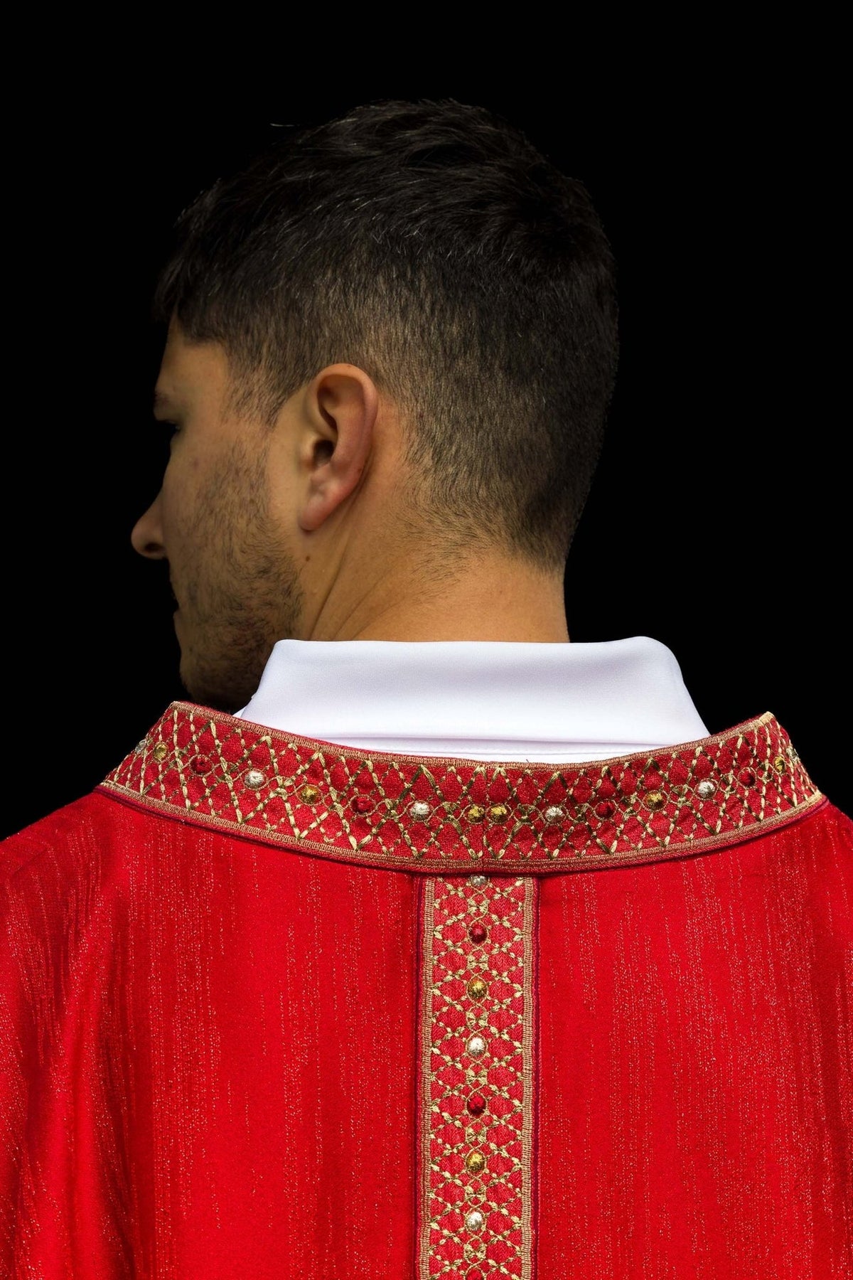 Red chasuble close-up of embroidered collar with gold lattice motifs