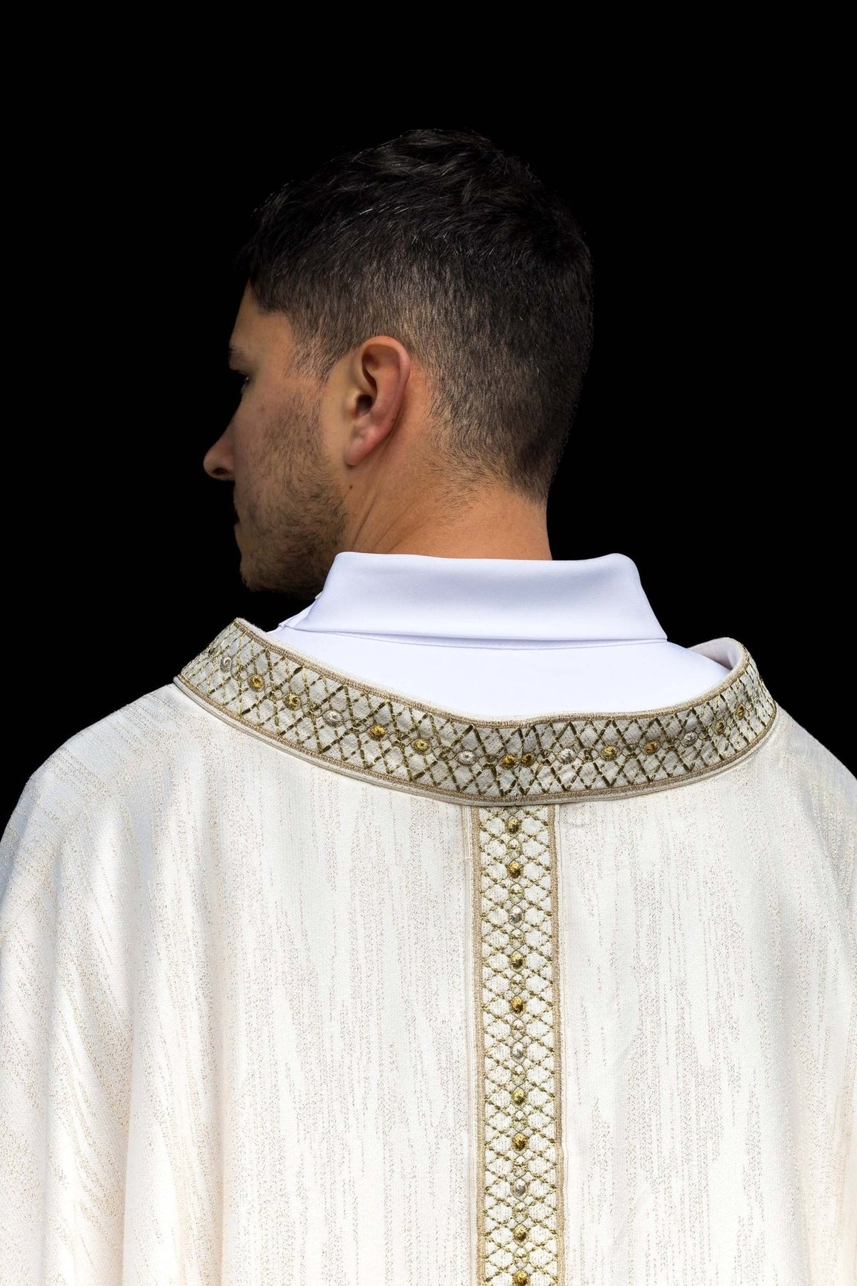 White chasuble back collar close-up with embroidered orphrey