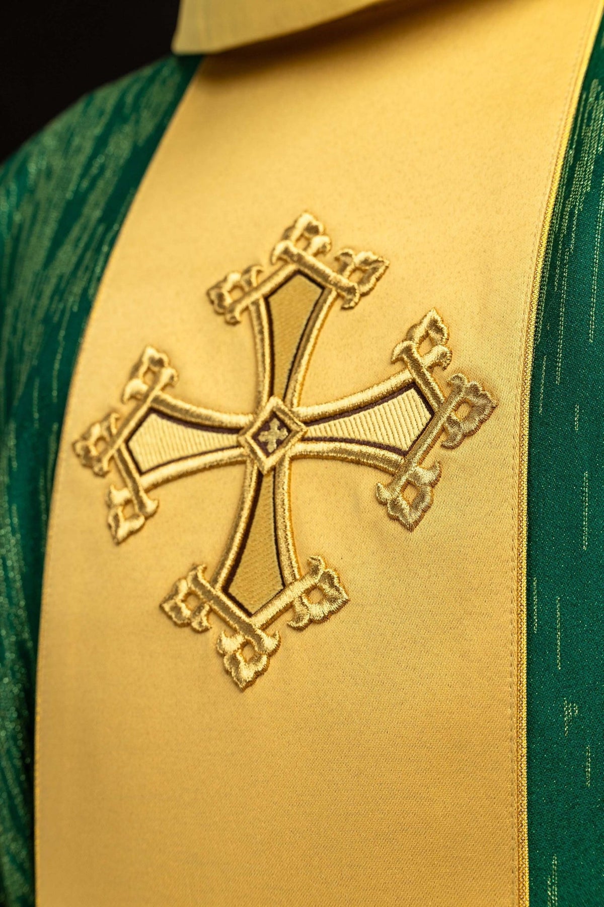 Green chasuble close-up of embroidered gold cross on orphrey
