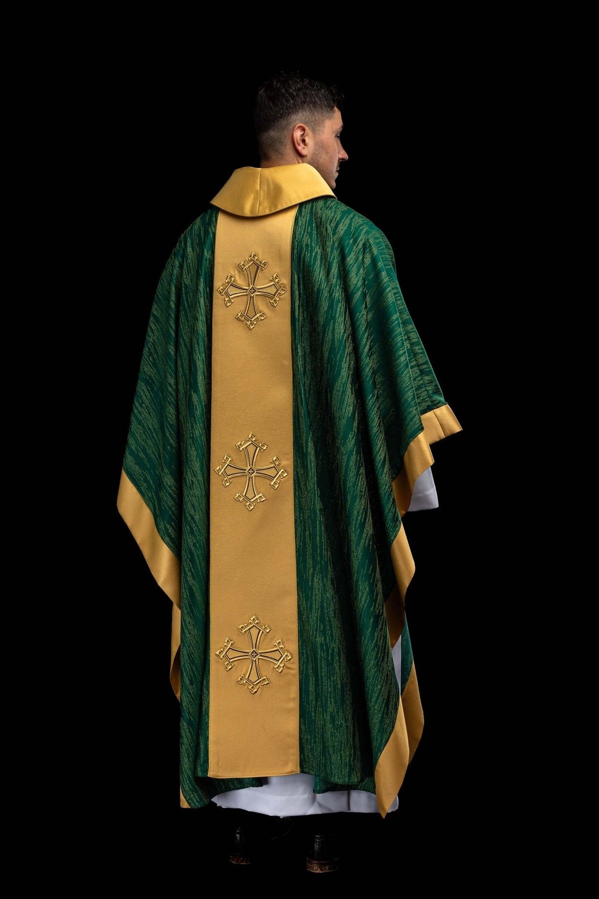 Green chasuble close-up of green fabric with gold vertical pattern