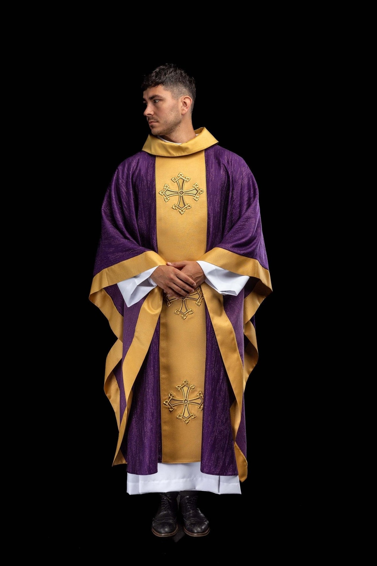 Purple chasuble worn front view with gold trim and embroidered crosses