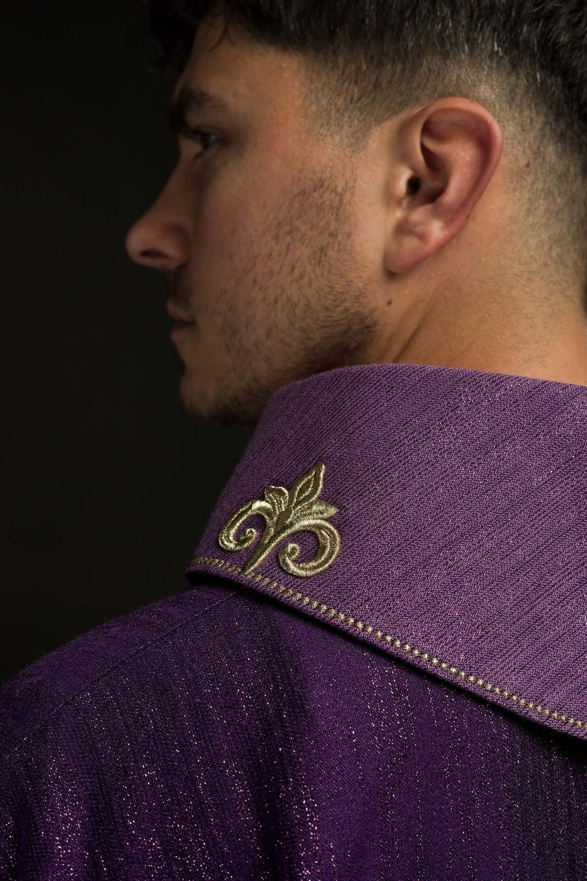 Purple chasuble side view with embroidered collar motif