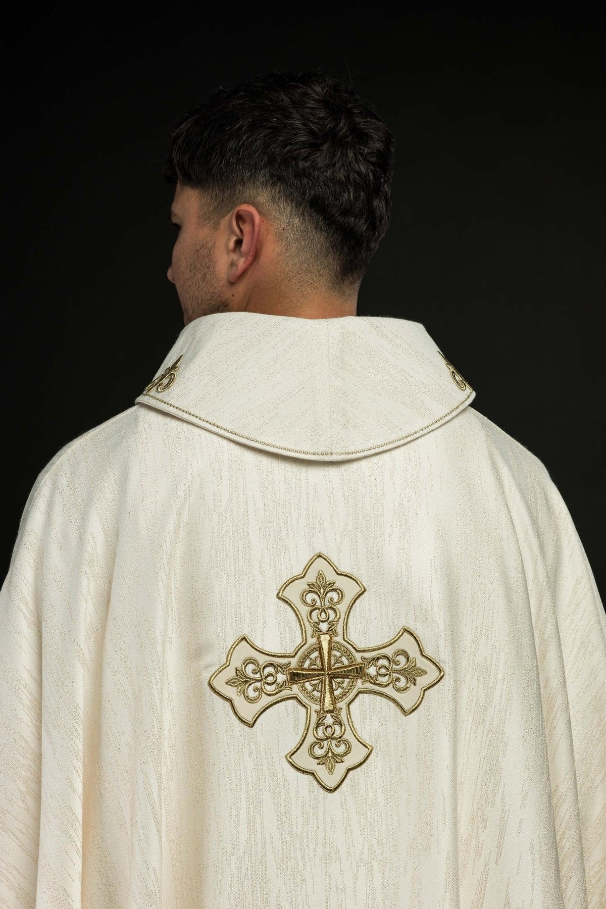 Ecru chasuble side view showing stand-up collar embroidery and textured fabric