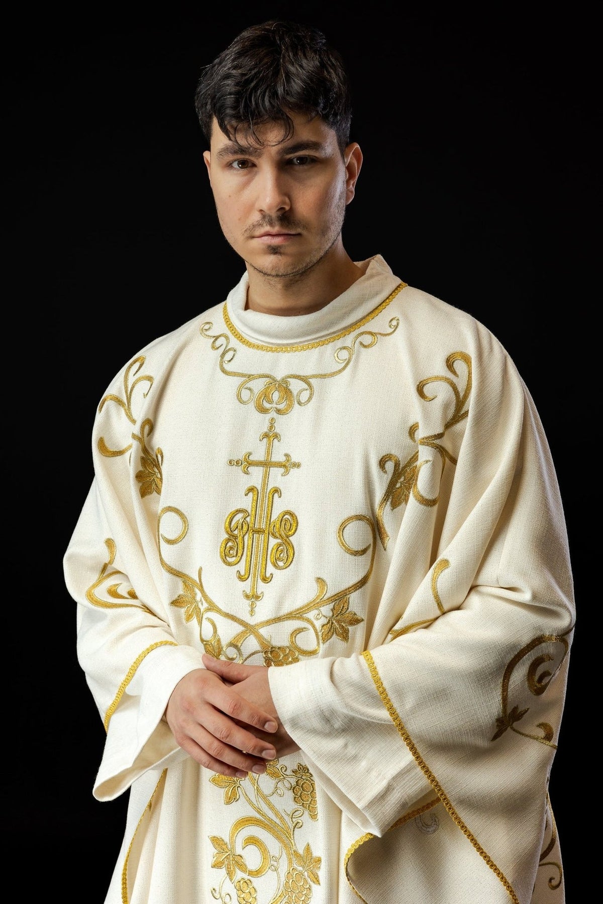 Ecru chasuble close-up showing gold IHS and grapes embroidery