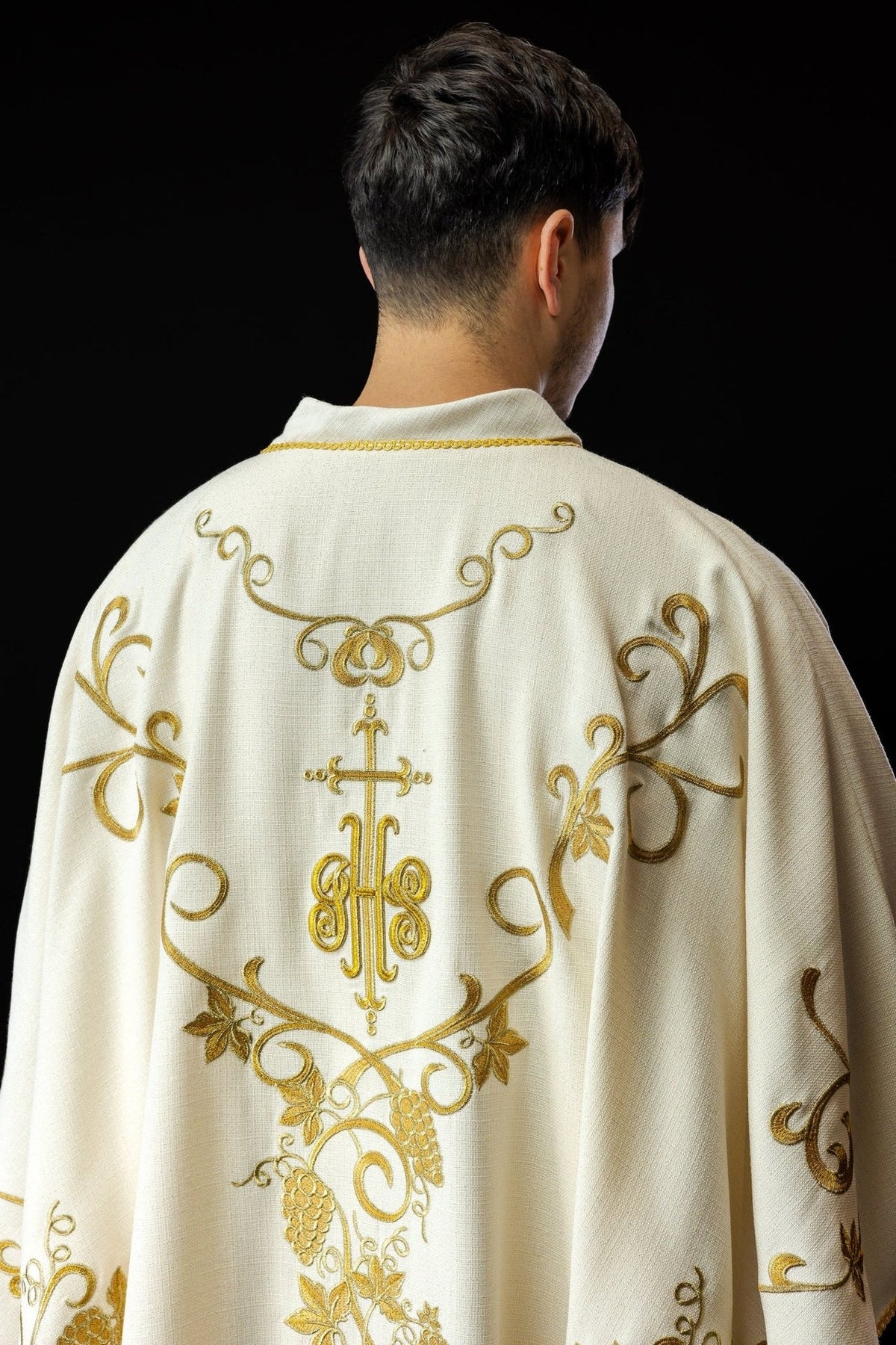 Ecru chasuble with matching stole showing IHS embroidery and gold tassels