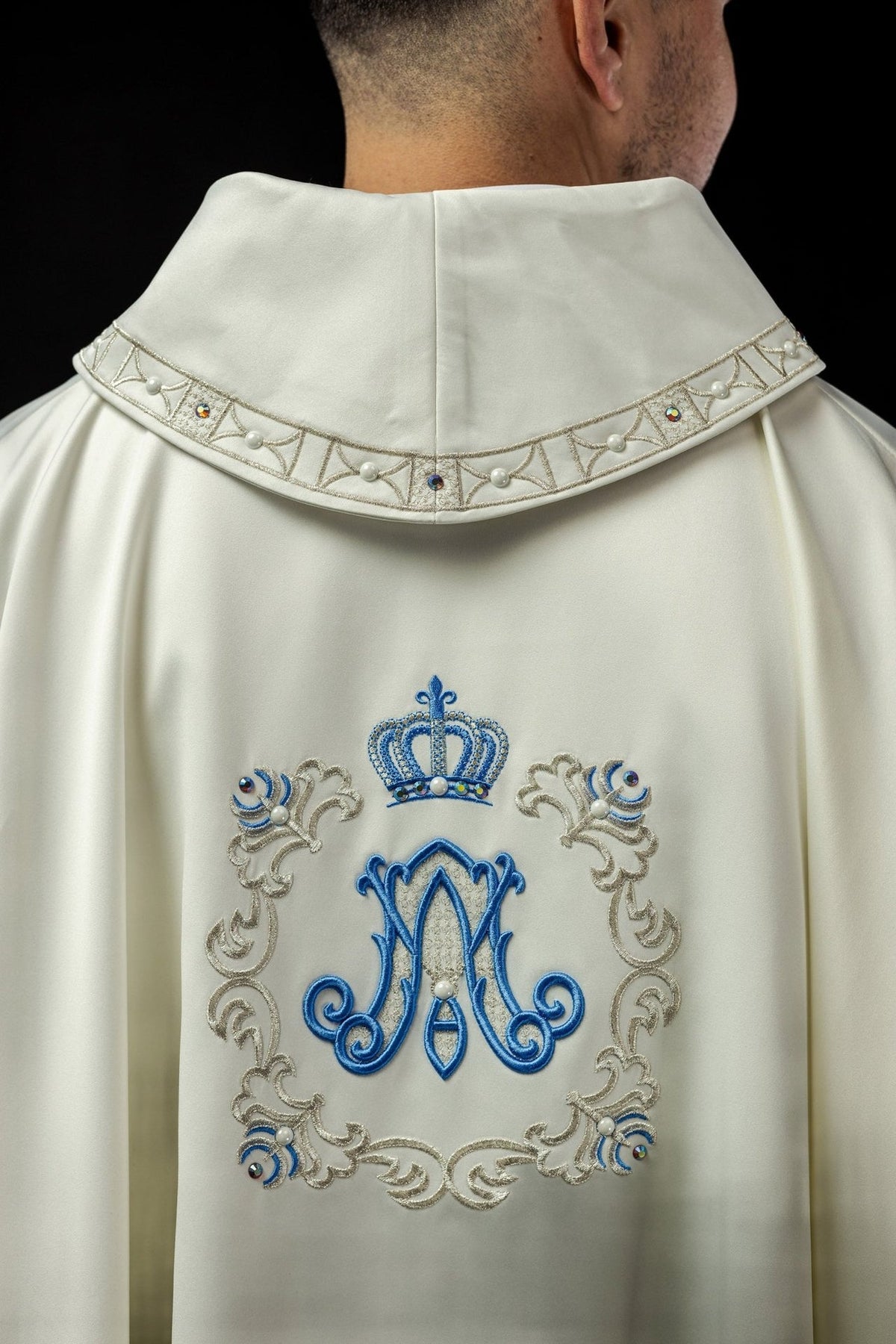Marian chasuble back view with ivory fabric, stand-up collar and blue Marian embroidery