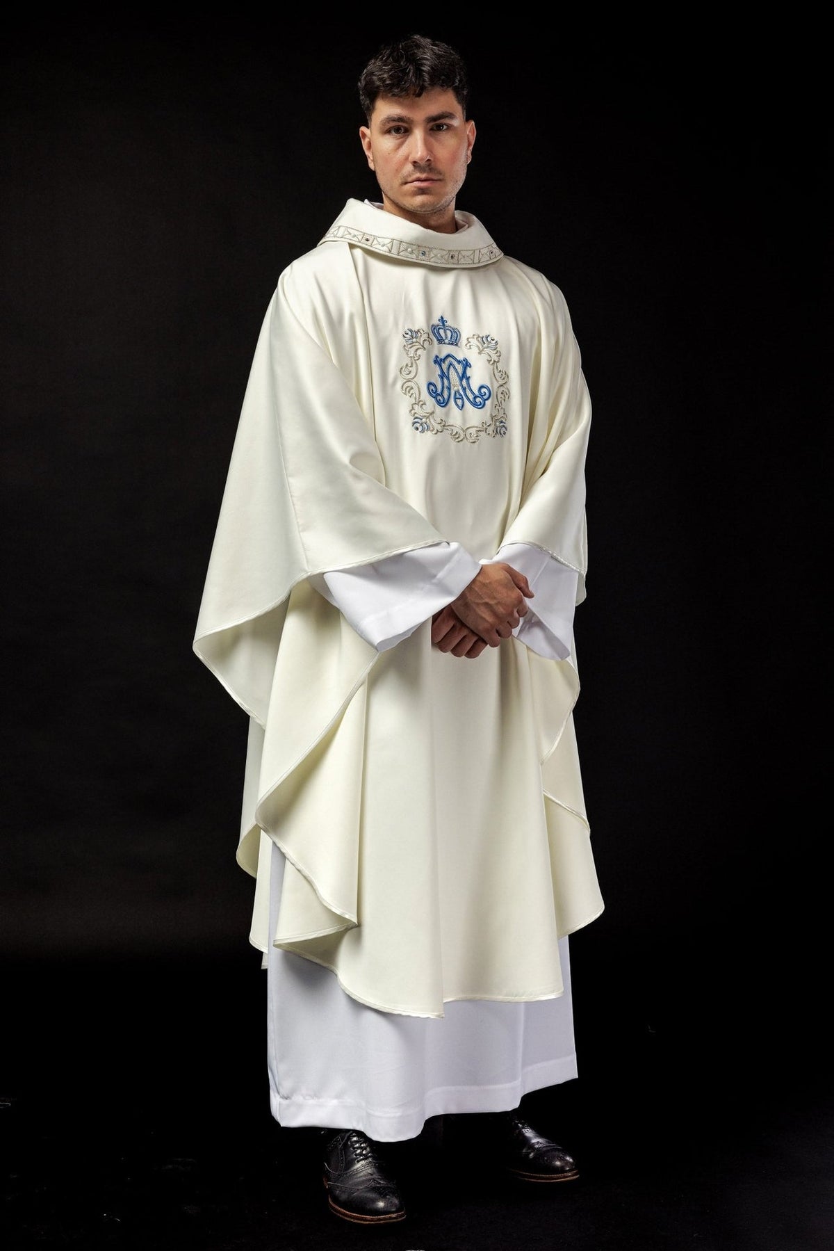 Marian chasuble front worn view with ivory fabric, gold trim and blue embroidered monogram