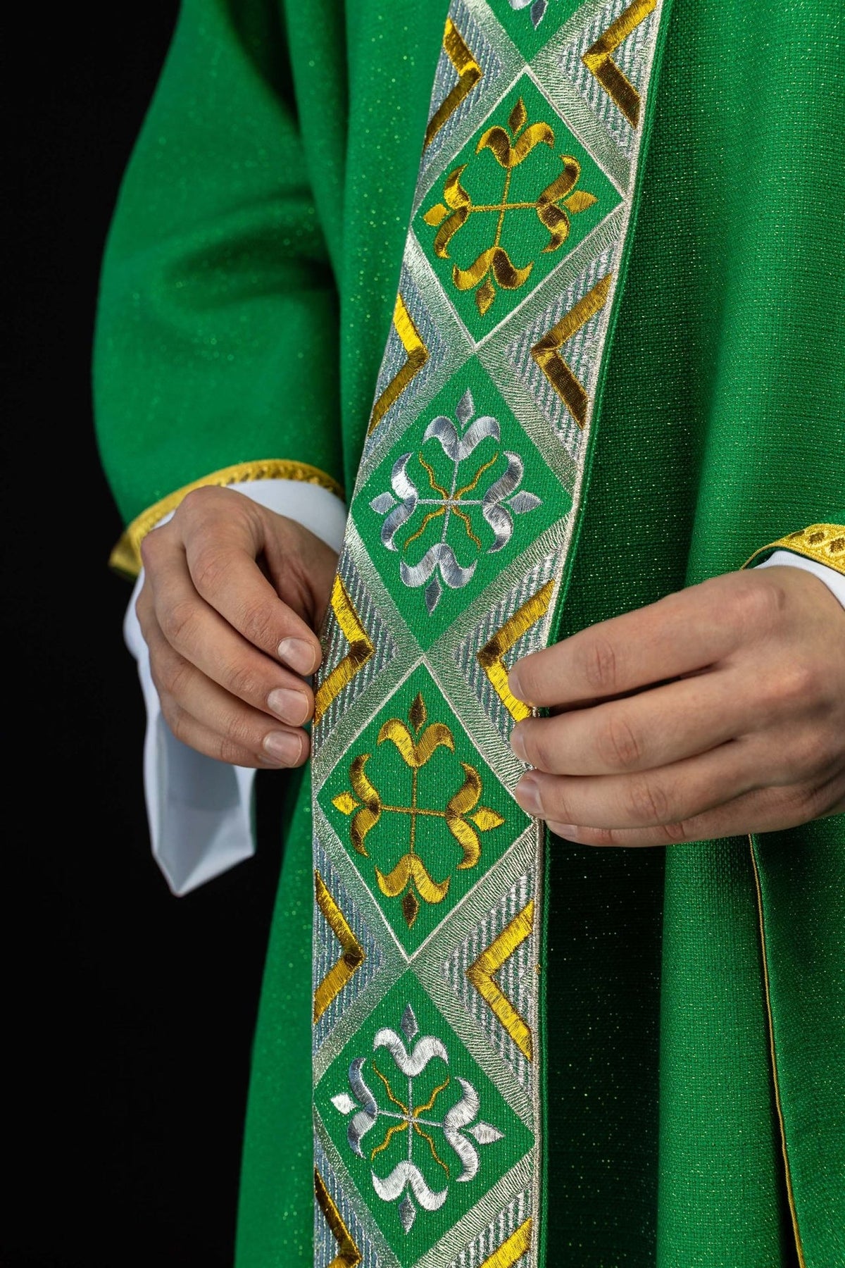Green chasuble orphrey close-up with alternating gold and silver embroidered motifs