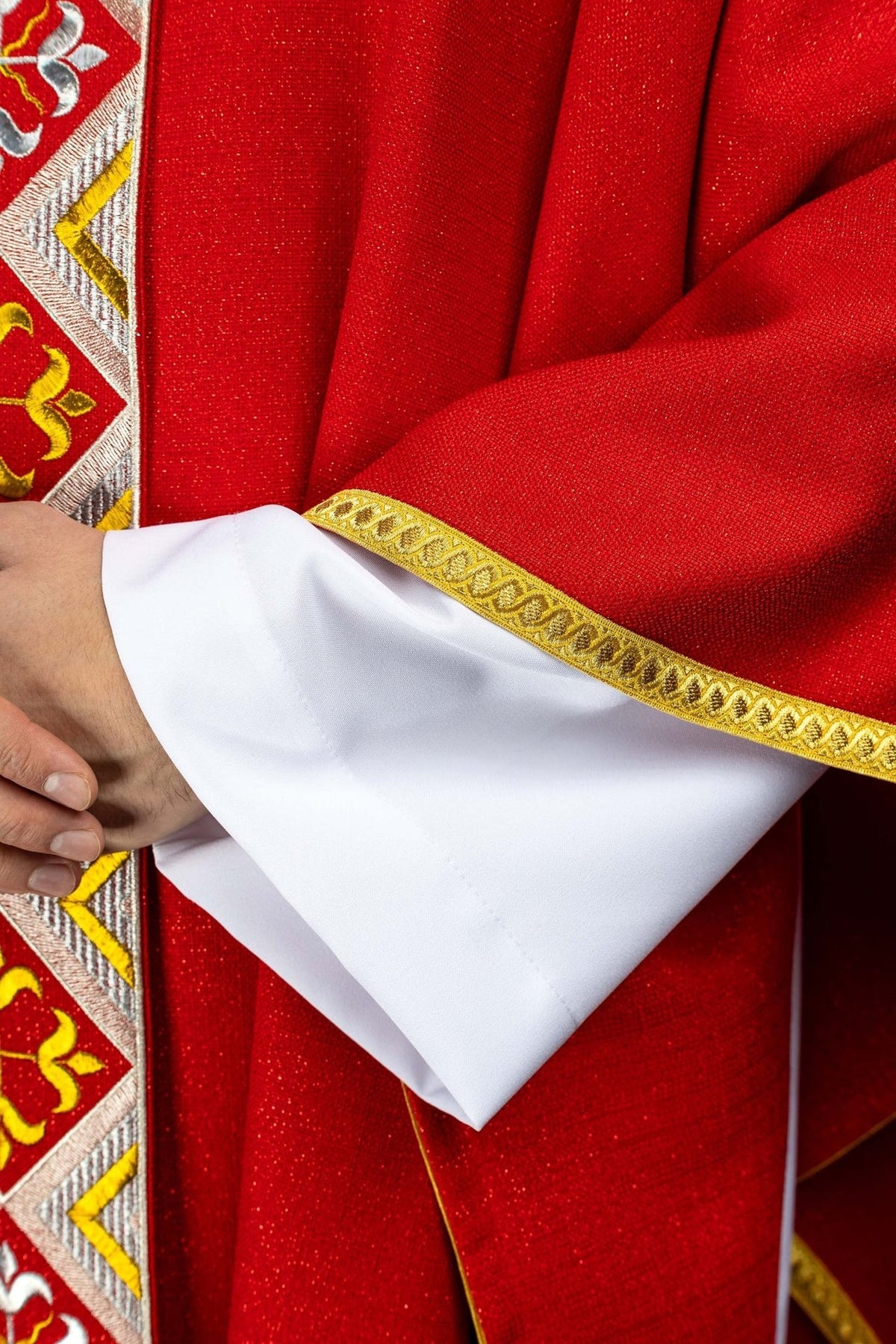 Red chasuble side view with long embroidered orphrey and gold edging