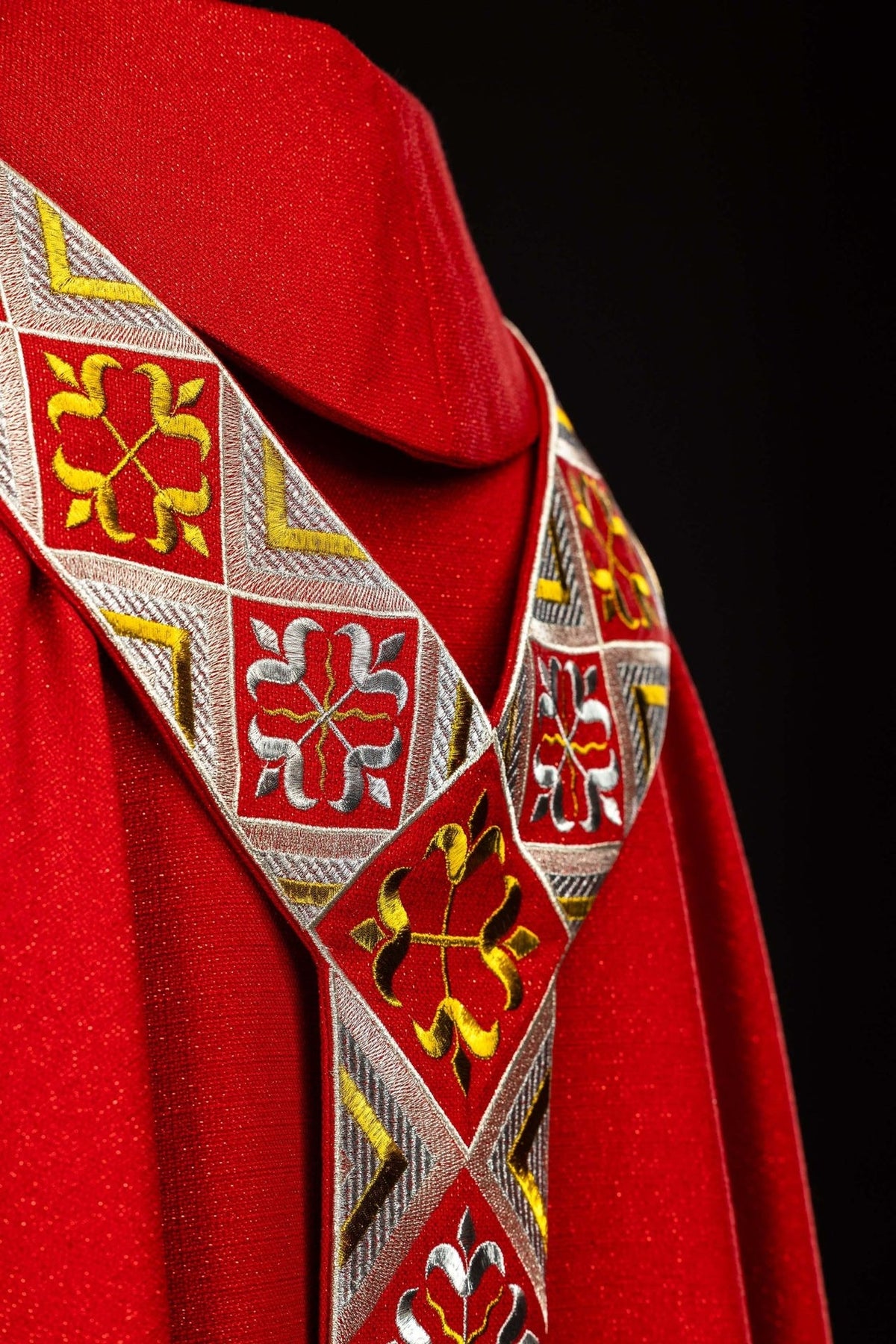 Red chasuble back view with embroidered orphrey and gold edging
