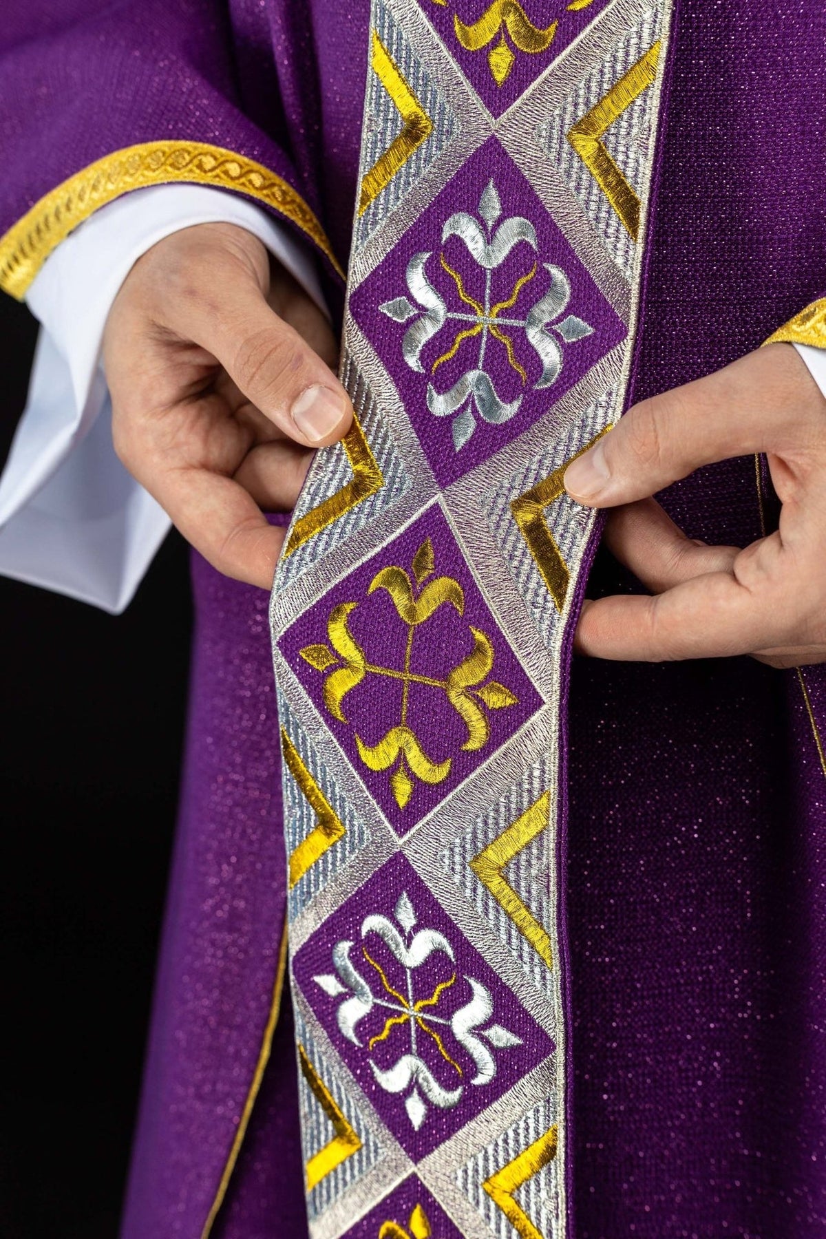 Purple chasuble close-up showing shimmering fabric and gold trim