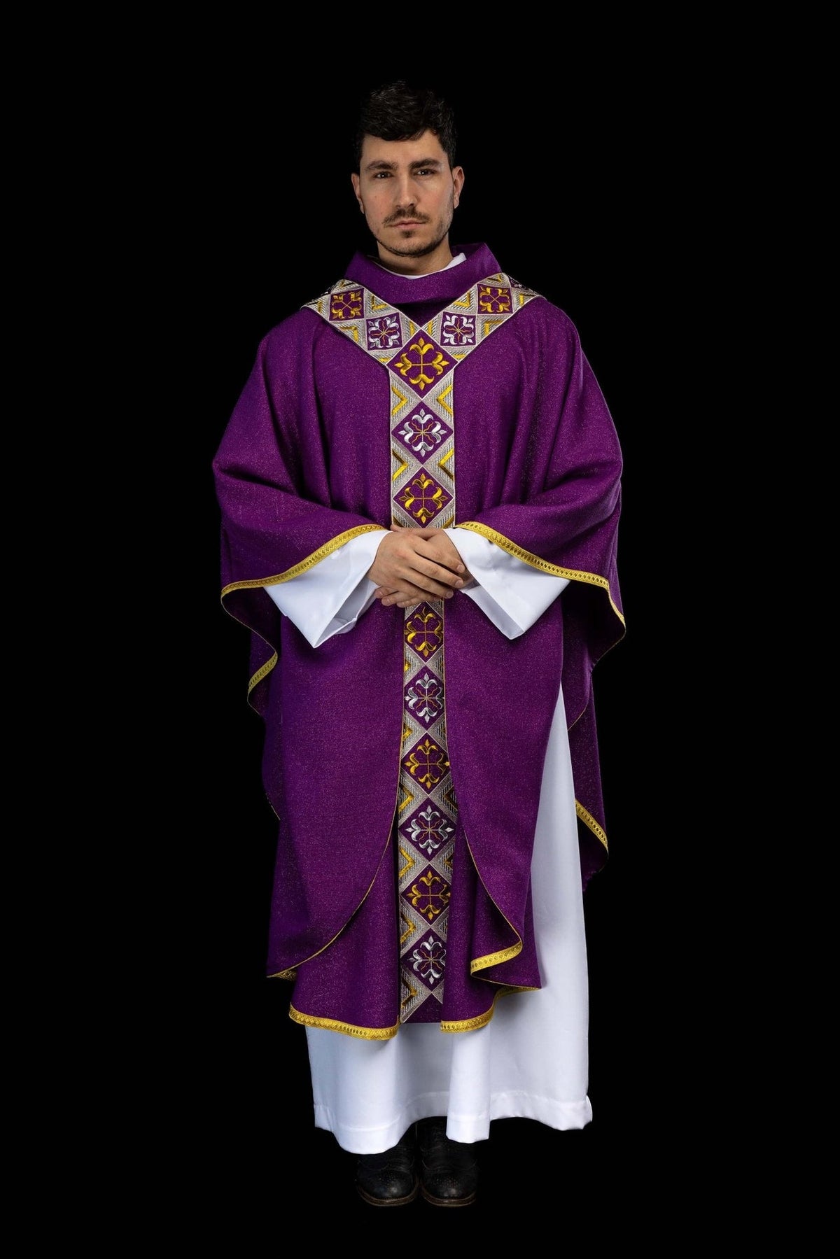 Purple chasuble close-up showing gold and silver embroidered cross motifs
