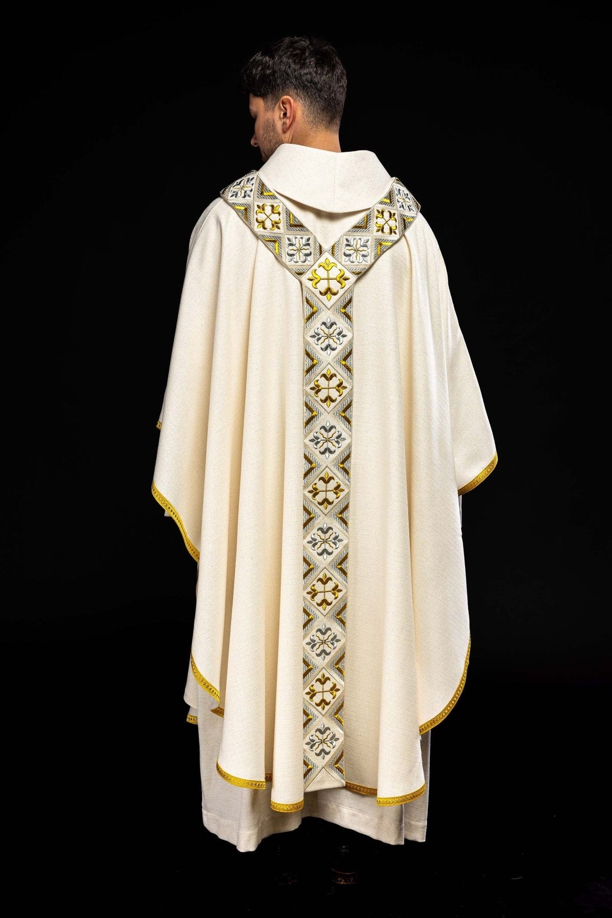 Back view of cream chasuble with gold and silver embroidery on the orphrey