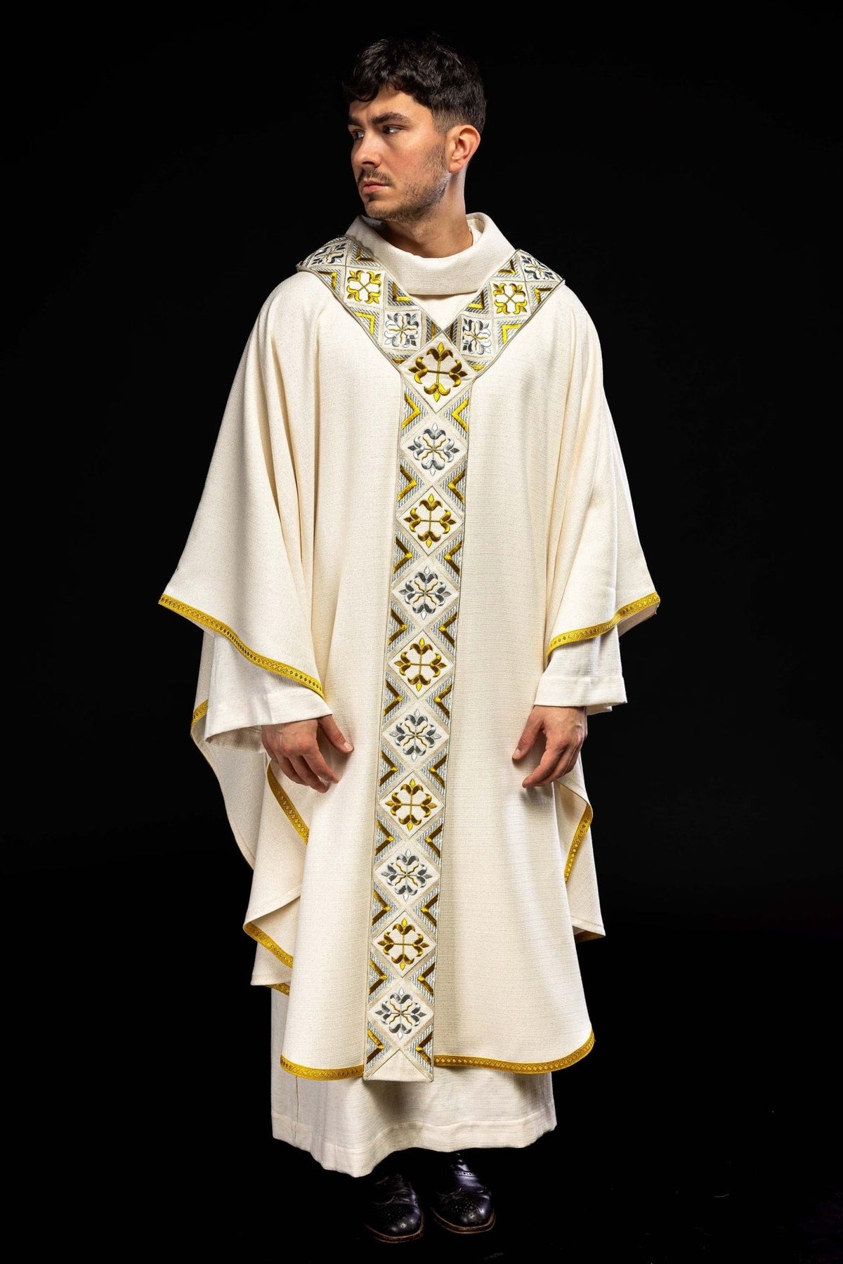 Front view of cream chasuble with repeating gold and silver embroidery