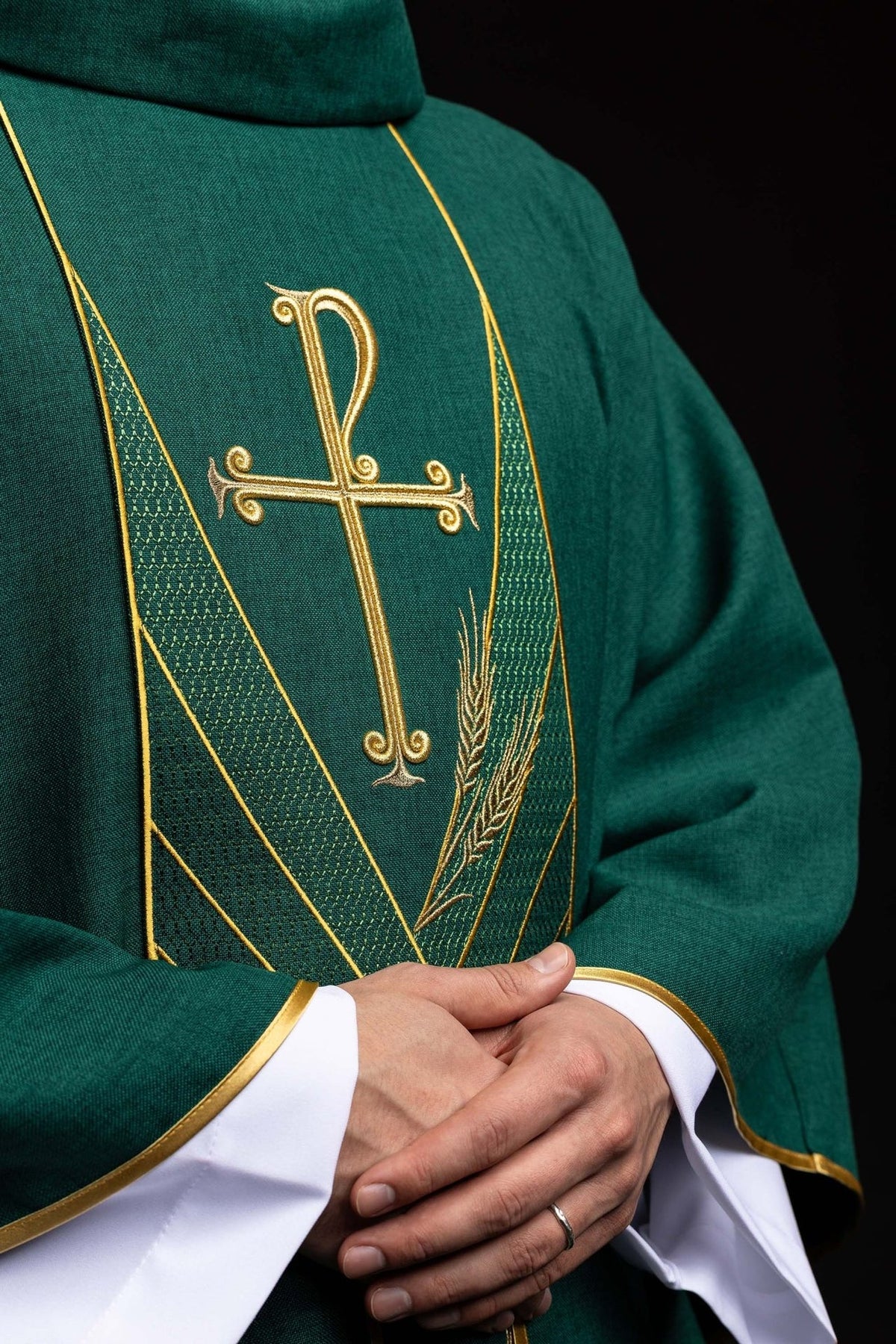 Green chasuble close-up with gold cross, wheat embroidery and green patterned orphrey
