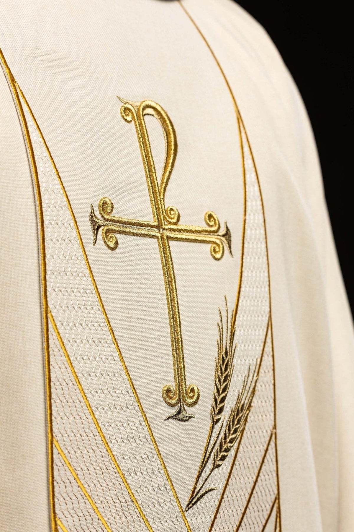 Ecru chasuble orphrey close-up with gold PAX cross and wheat embroidery