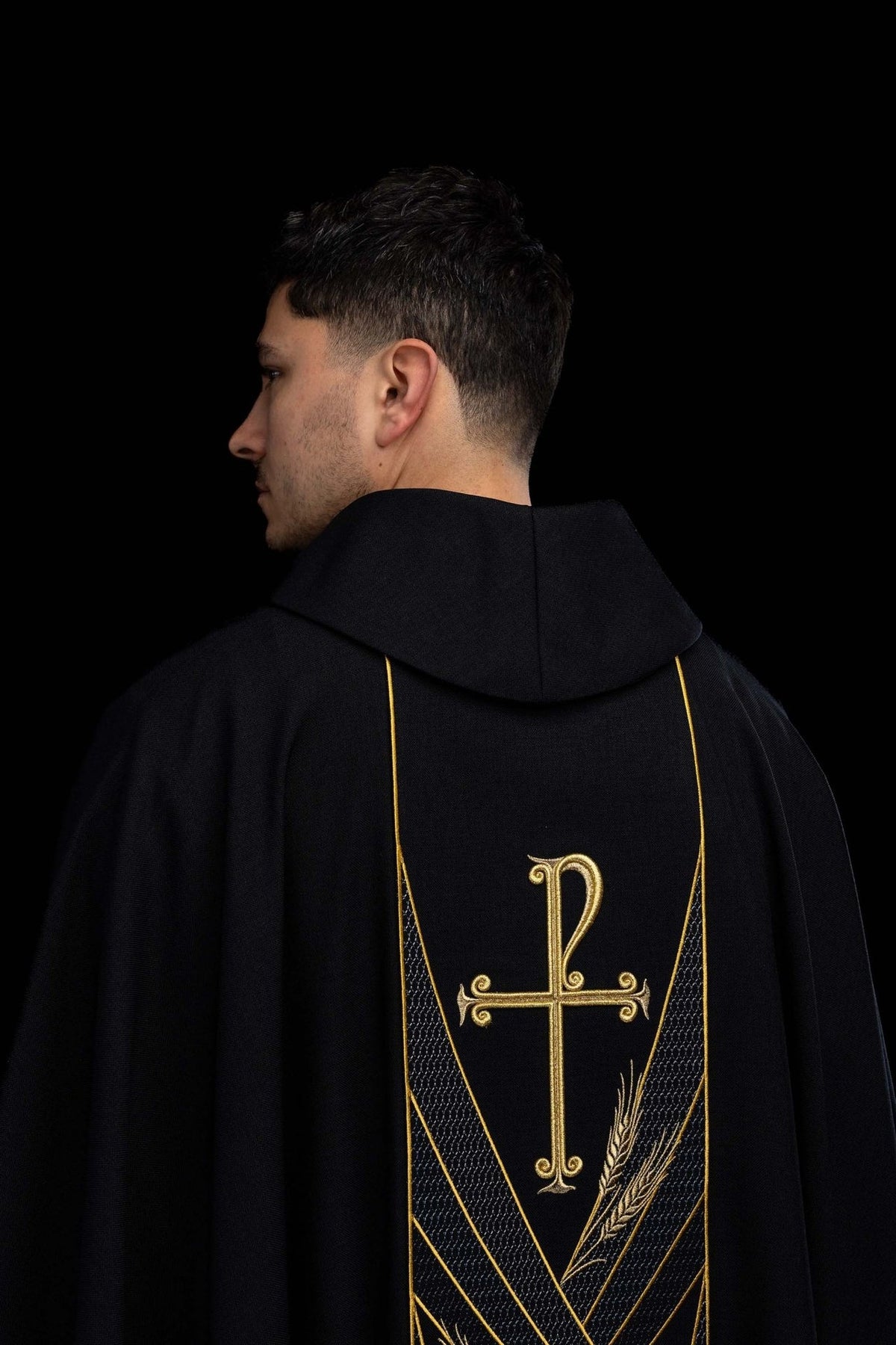 Black chasuble back view with gold PAX cross, wheat embroidery and orphrey