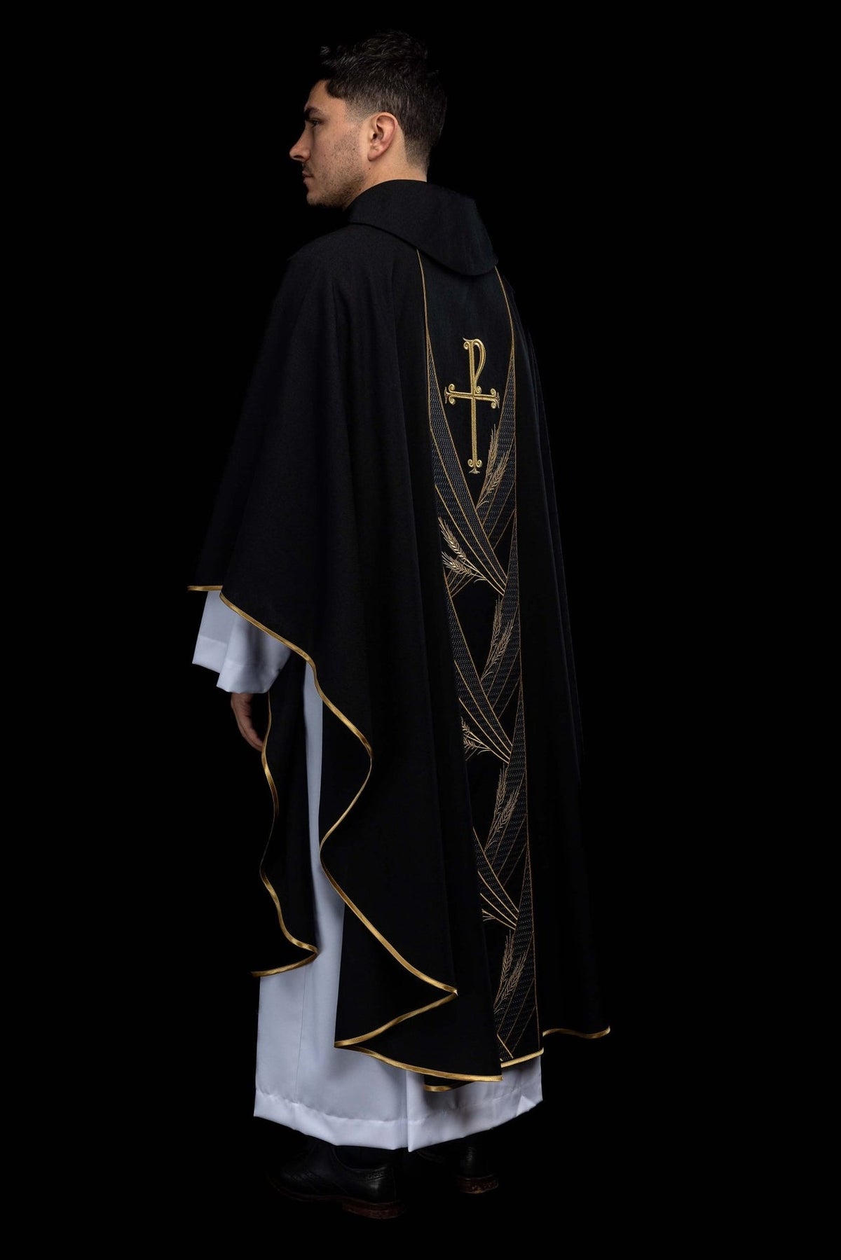 Black chasuble side view showing gold trim and embroidered orphrey