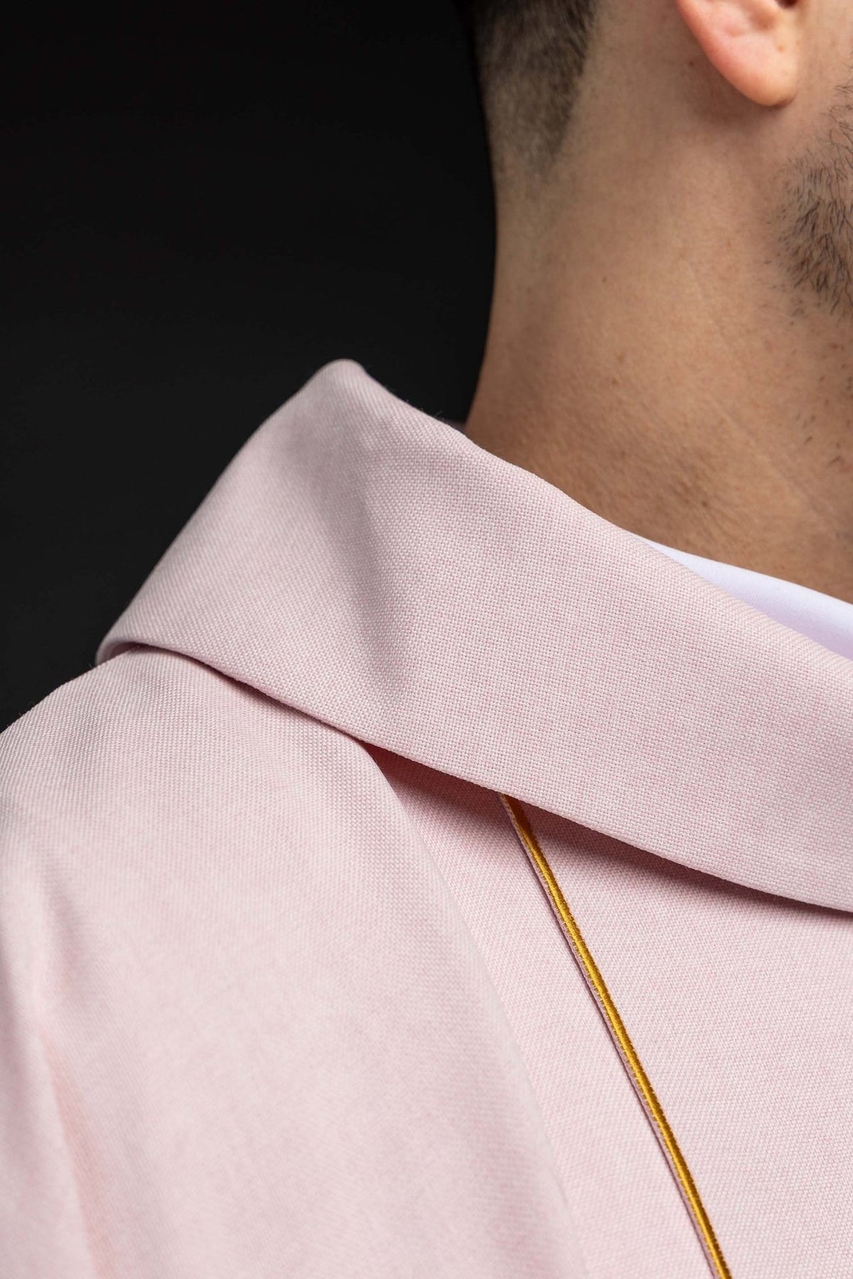Rose chasuble close-up showing stand-up collar and gold trim