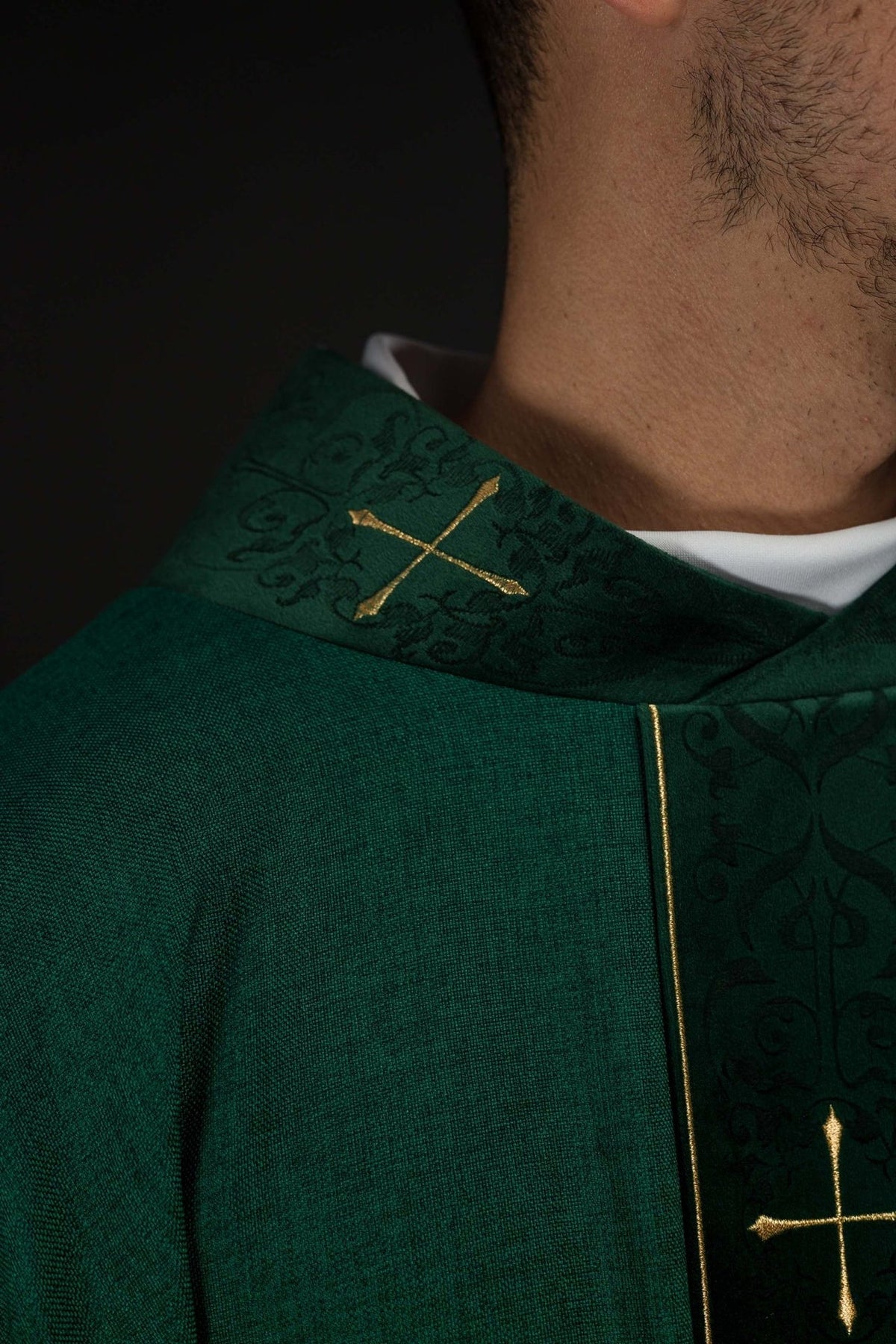 Green chasuble close-up of cross-patterned collar and gold-trimmed orphrey