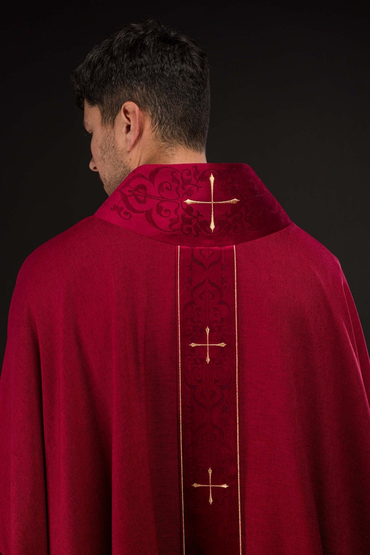 Red chasuble back view with embroidered orphrey and gold crosses