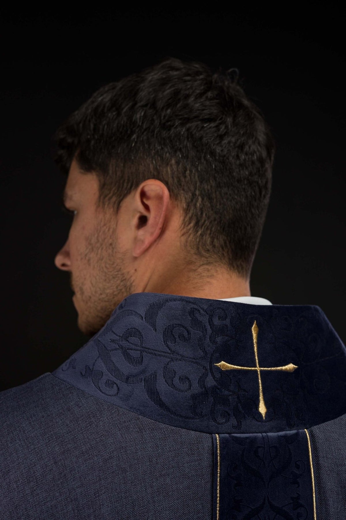 Purple chasuble back close-up with embroidered collar and gold cross
