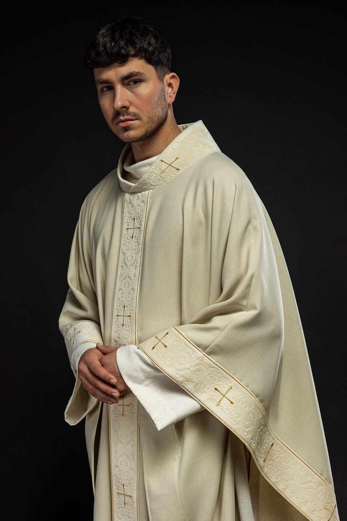 Ecru chasuble worn in a three-quarter front view with embroidered orphrey and gold crosses
