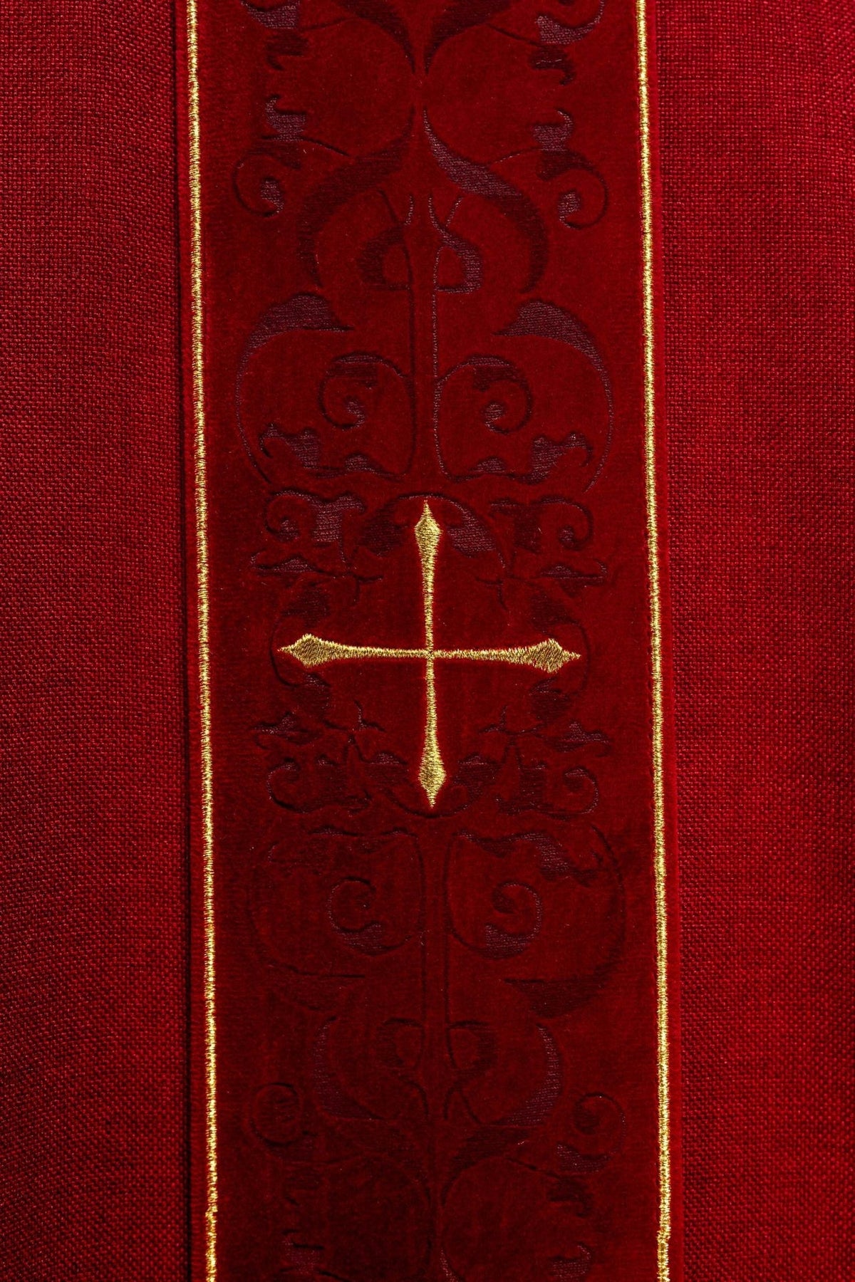 Red chasuble detail showing gold trim on sleeves and white cuffs