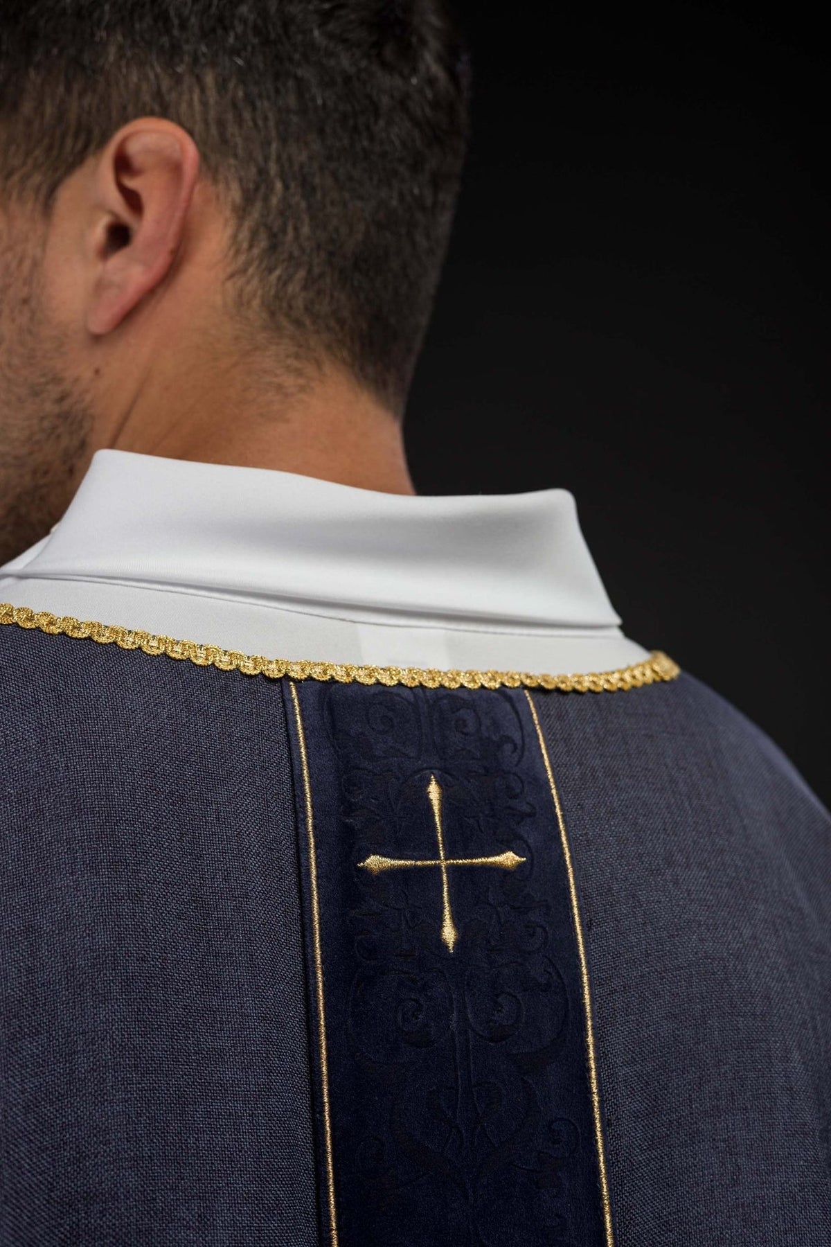 Purple chasuble back close-up with gold-trimmed orphrey and cross