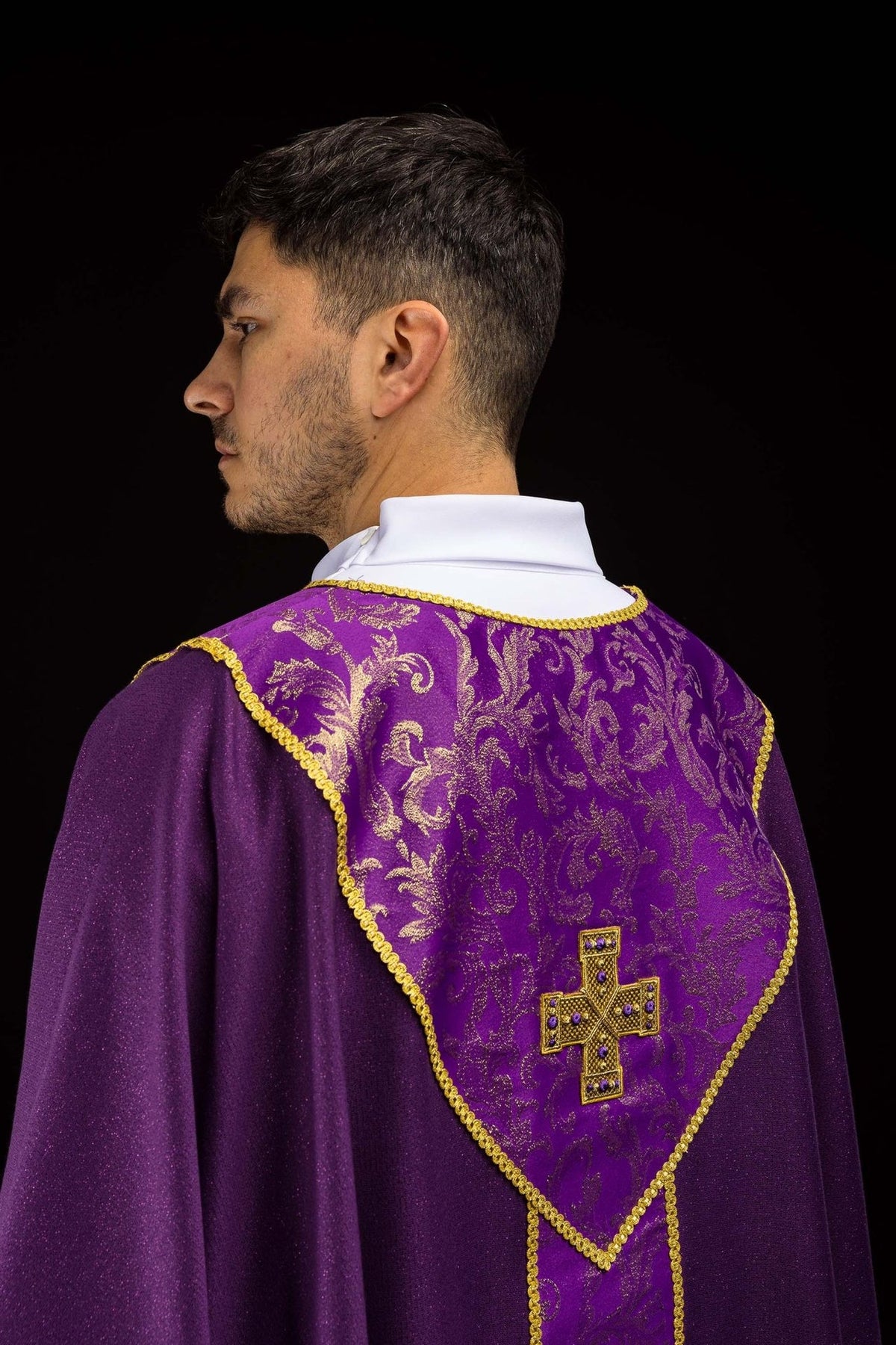 Purple chasuble back view with gold cross and jacquard fabric