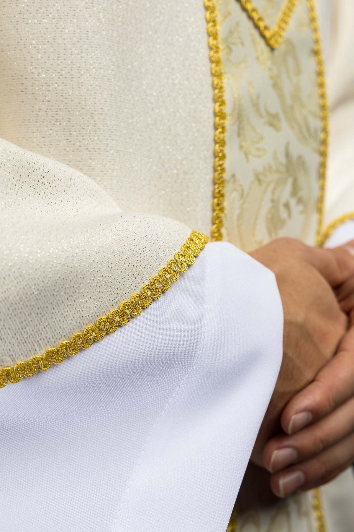 Ecru chasuble detail showing gold edging and jacquard orphrey