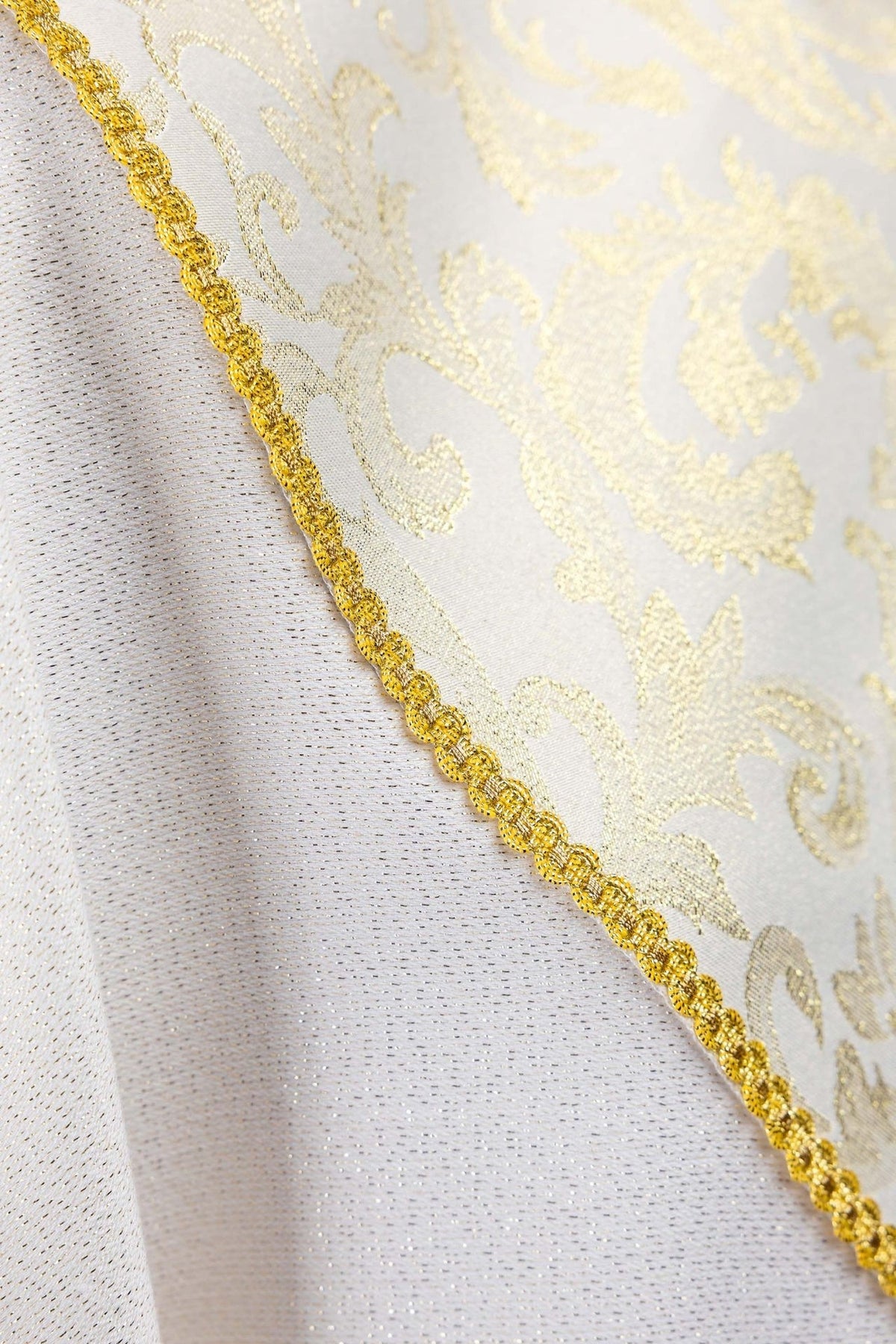 Ecru chasuble close-up of gold trim on jacquard fabric