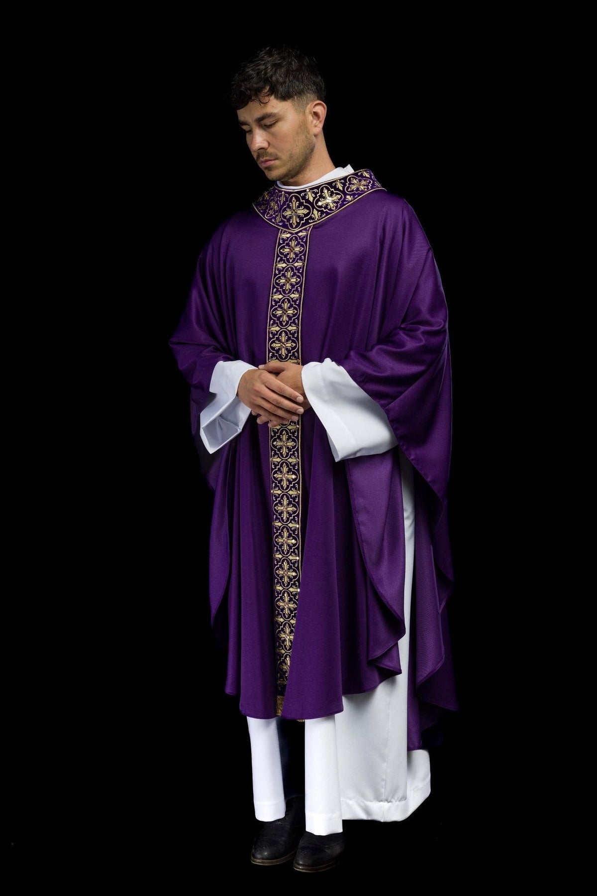 Purple chasuble worn front three-quarter view with gold cross embroidery