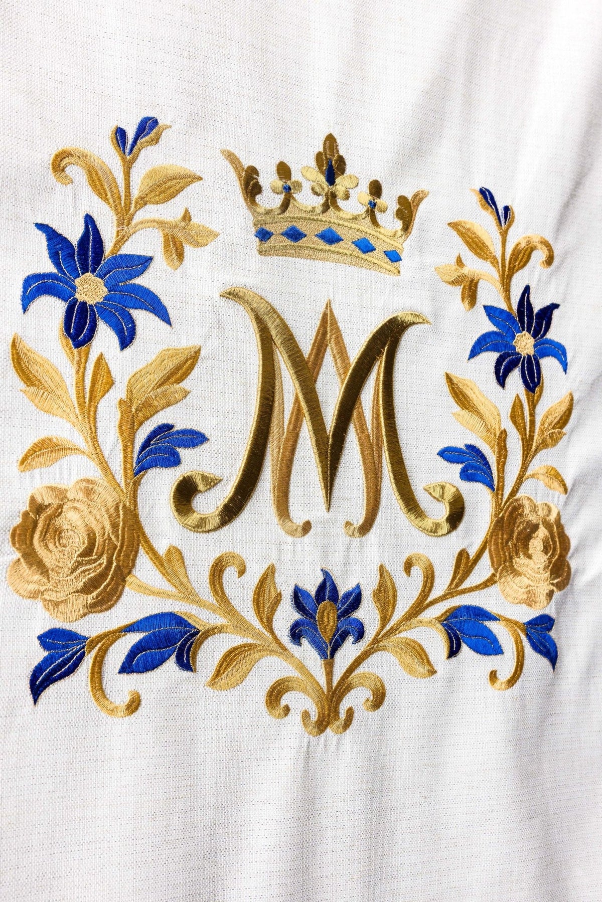 Church lectern cover close-up showing gold and blue Marian embroidery