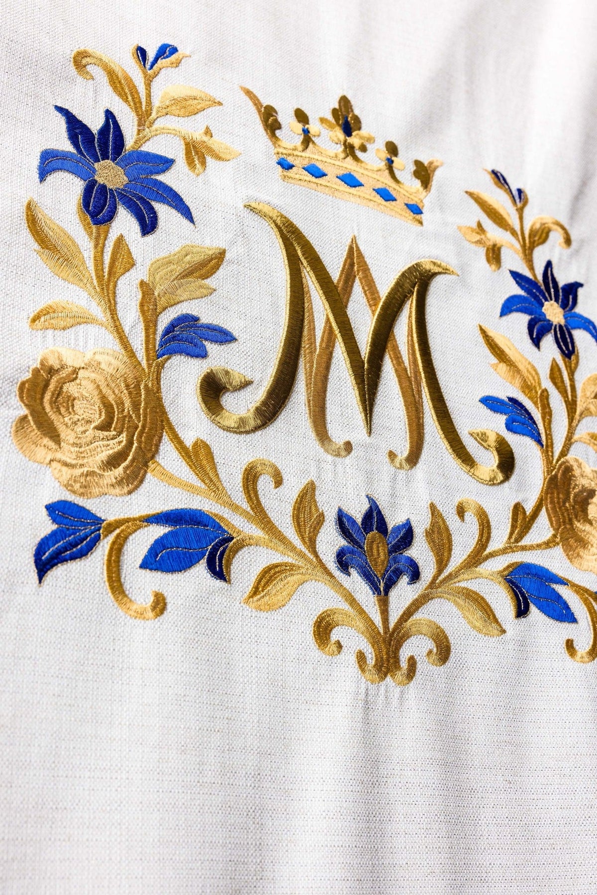 Church lectern cover close-up of gold monogram, blue flowers and Marian embroidery