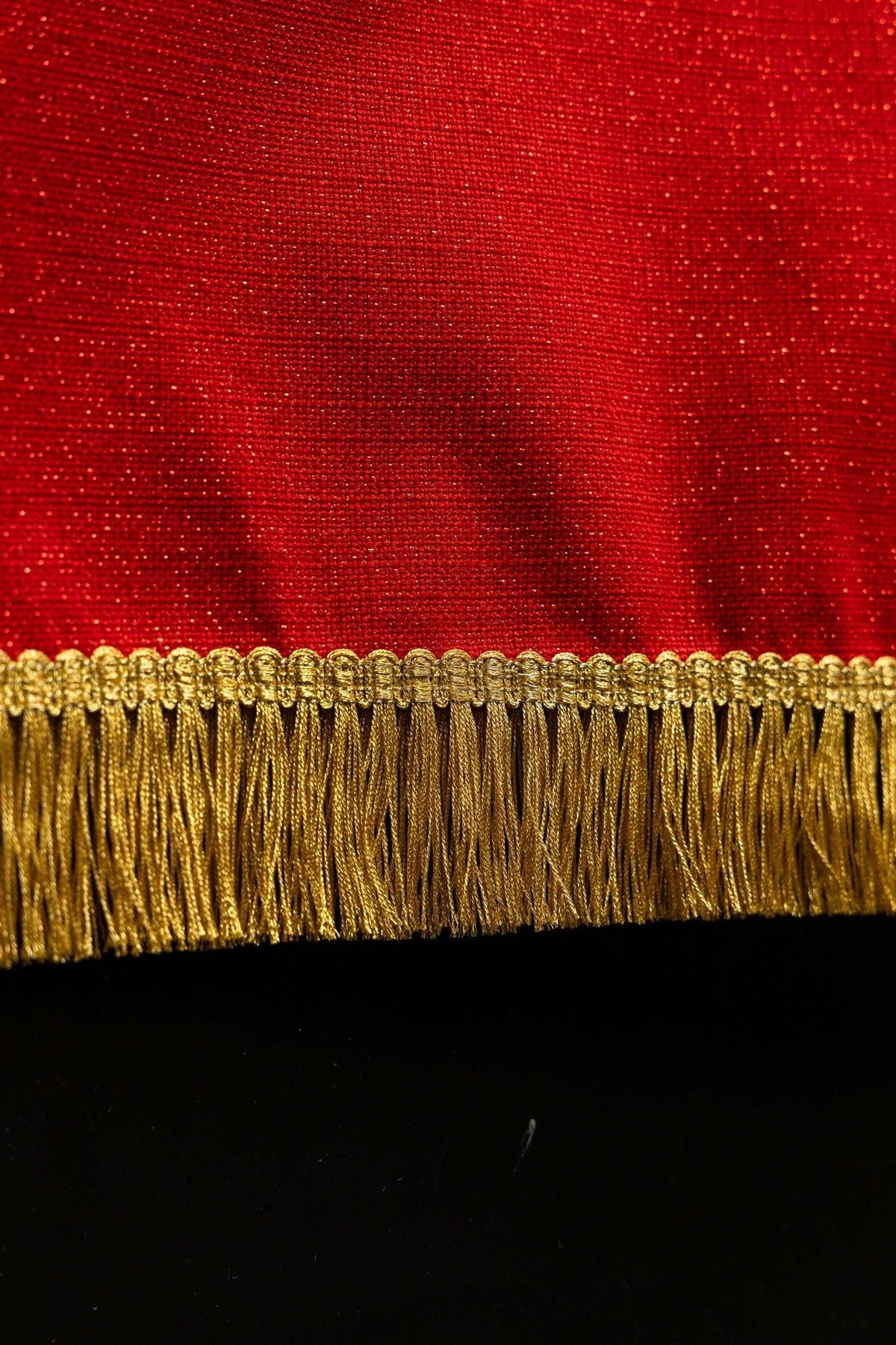 Church lectern cover close-up of red fabric and gold embroidered fringe