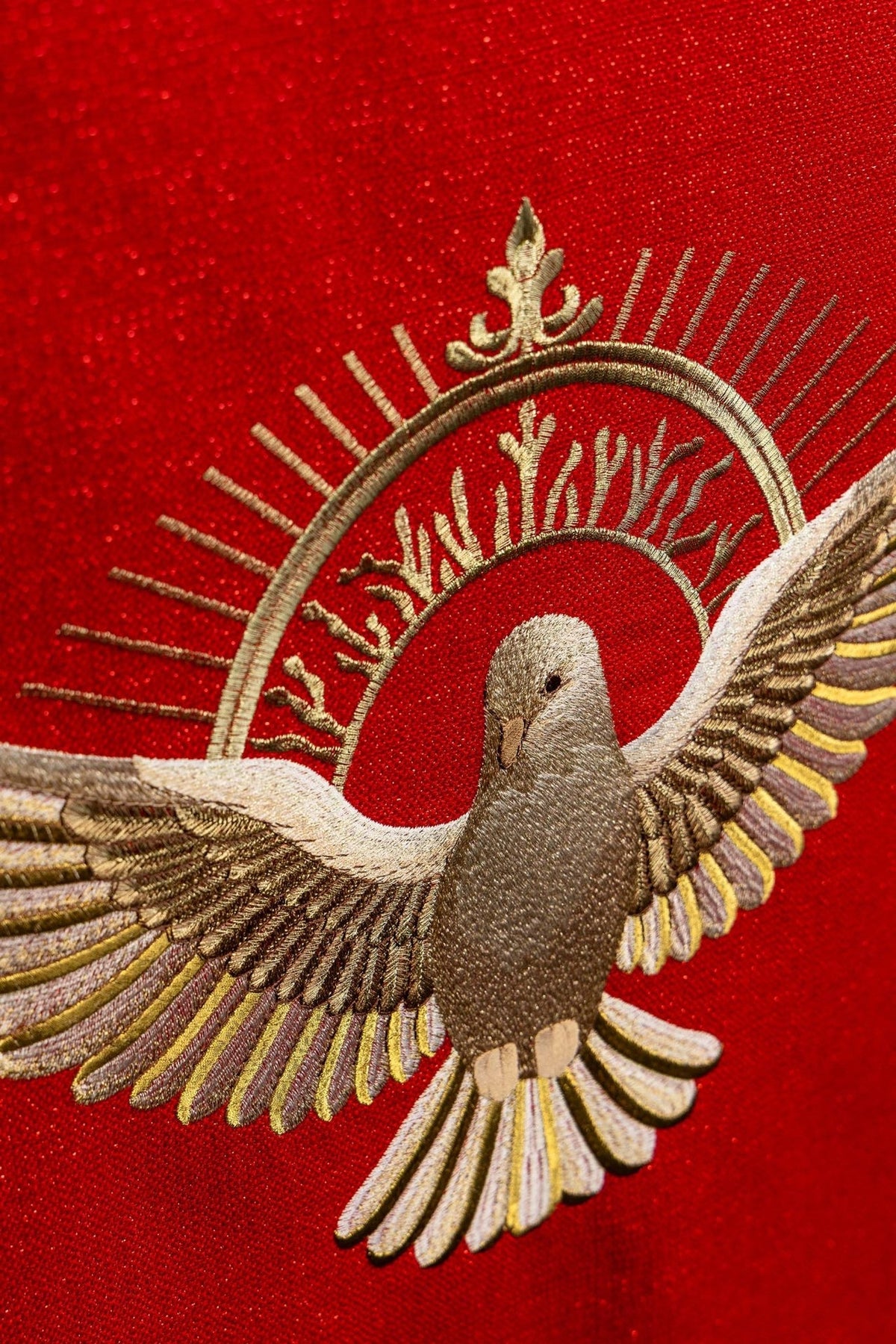 Church lectern cover close-up of embroidered Holy Spirit dove and gold halo