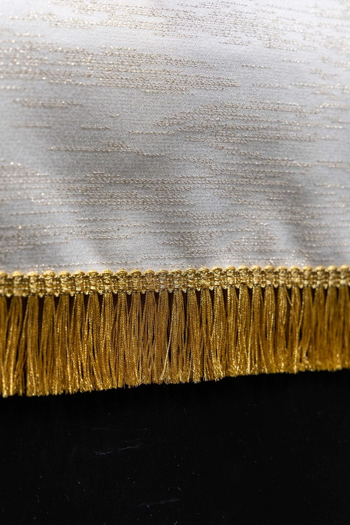 Ecru lectern cover close-up showing gold IHS monogram, grapes, wheat and vine embroidery