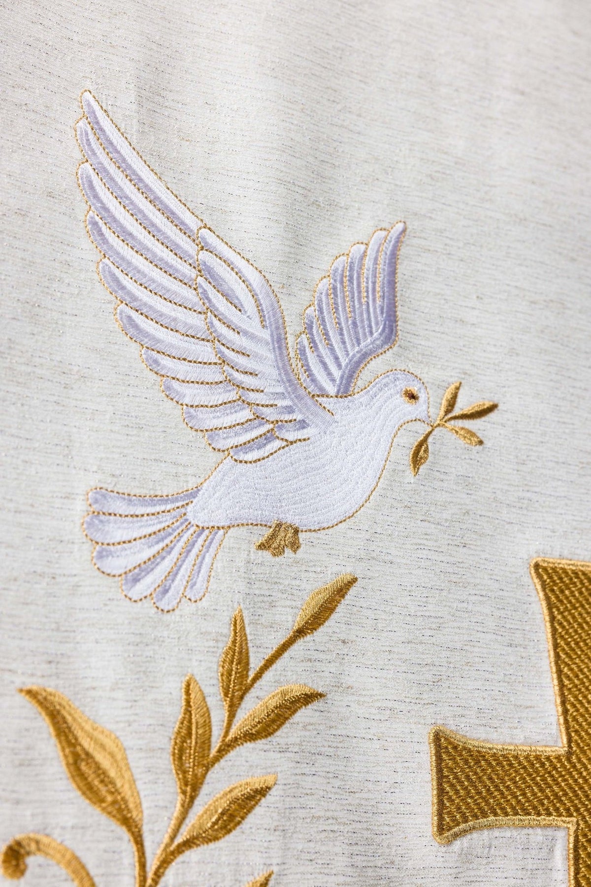 Church lectern cover close-up of a white dove with gold outline and floral embroidery