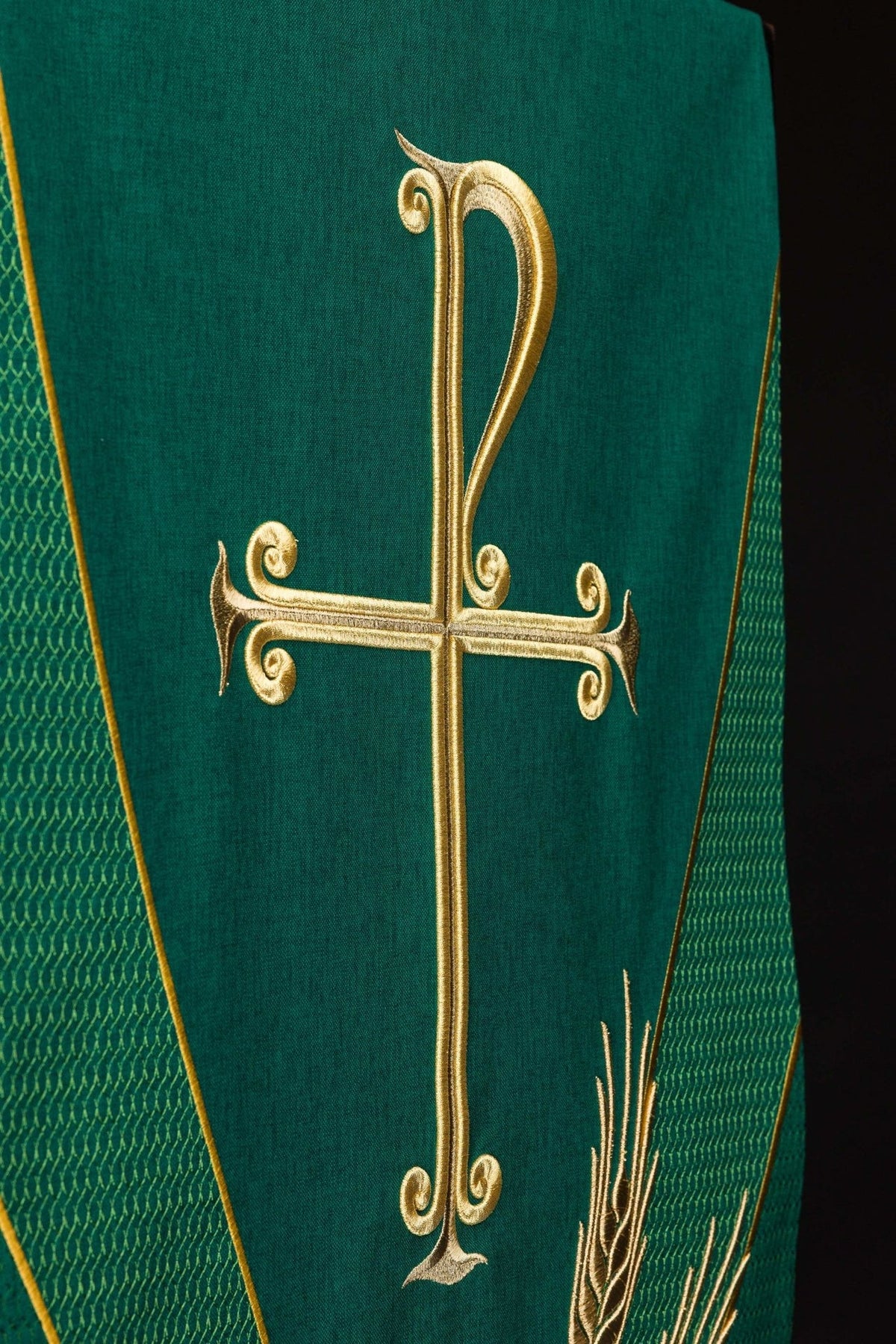 Green church lectern cover close-up showing gold PAX cross embroidery