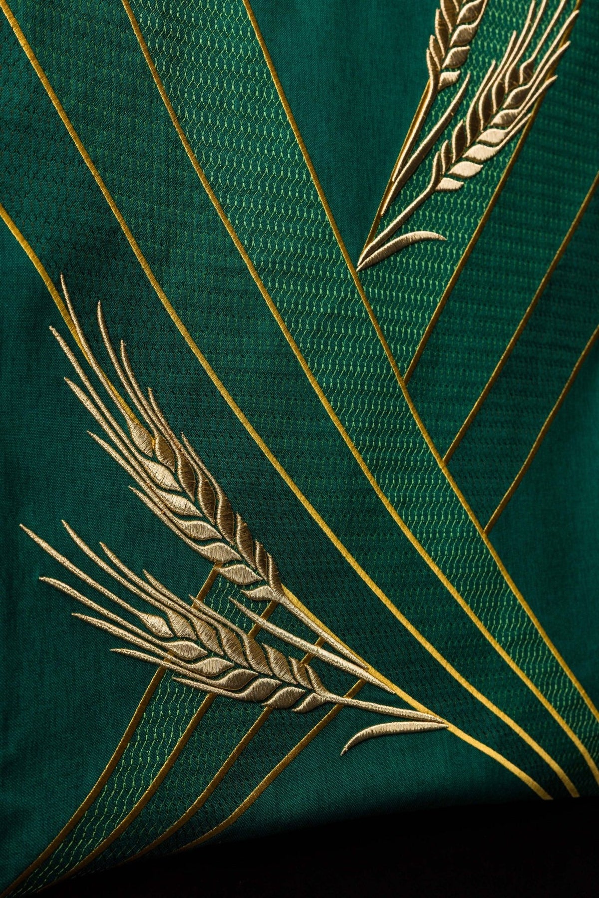 Green church lectern cover detail with gold wheat embroidery and diagonal bands