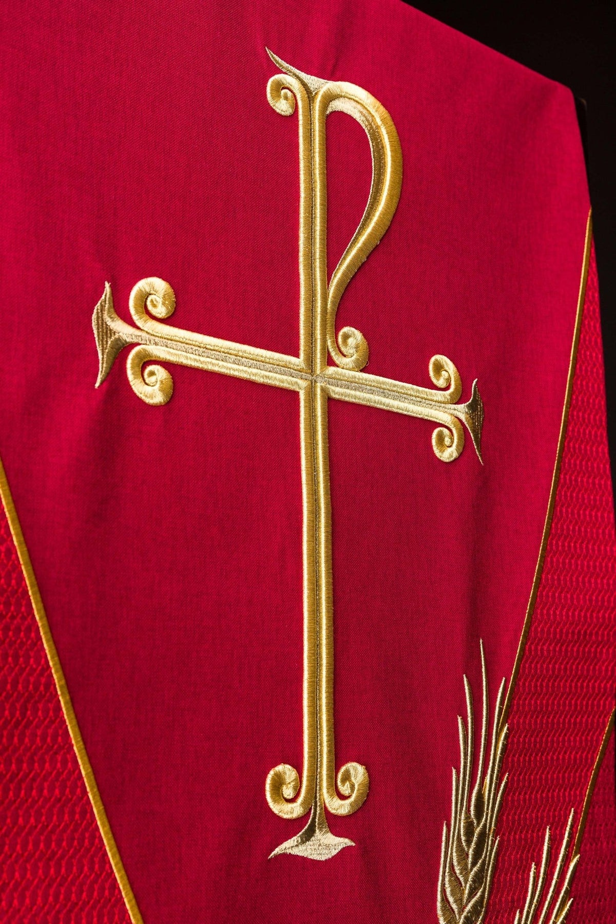 Church lectern cover close-up showing gold PAX cross embroidery on red fabric