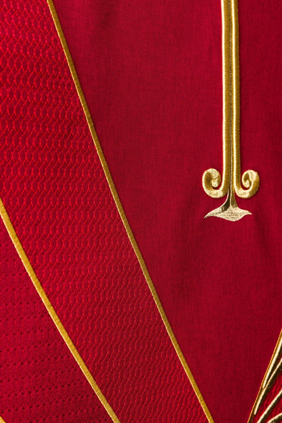 Red lectern cover detail with gold edging and textured red embroidery