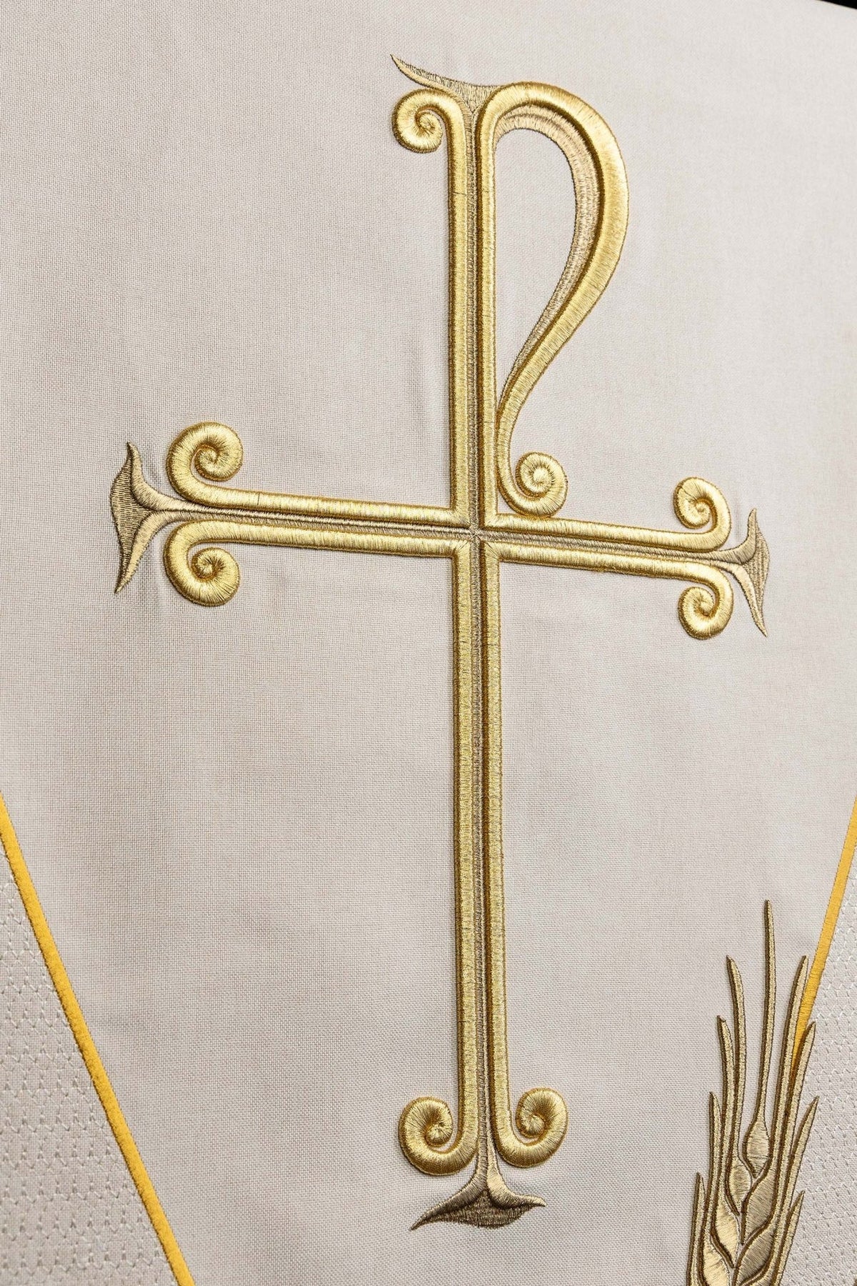 Church lectern cover close-up of gold cross embroidery on ecru fabric