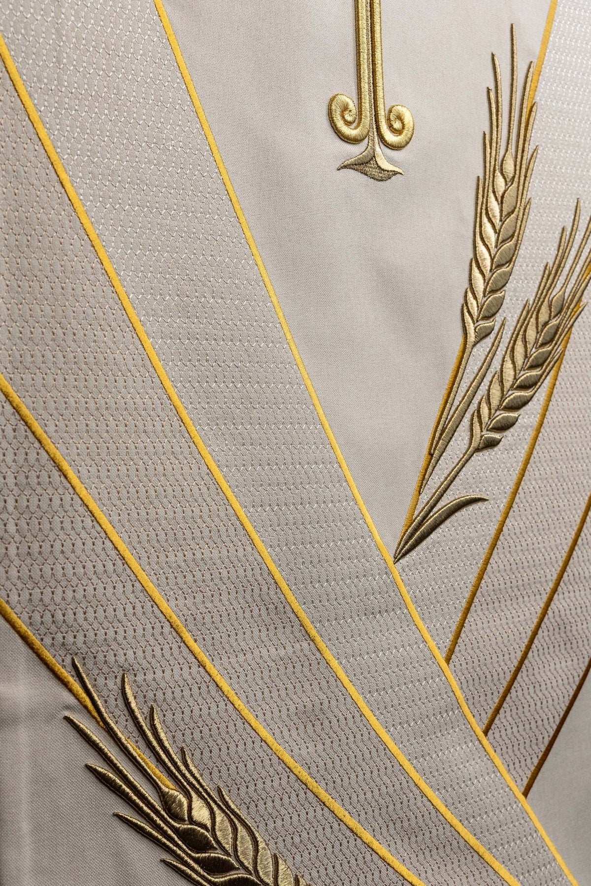 Church lectern cover close-up of gold wheat embroidery and diagonal bands