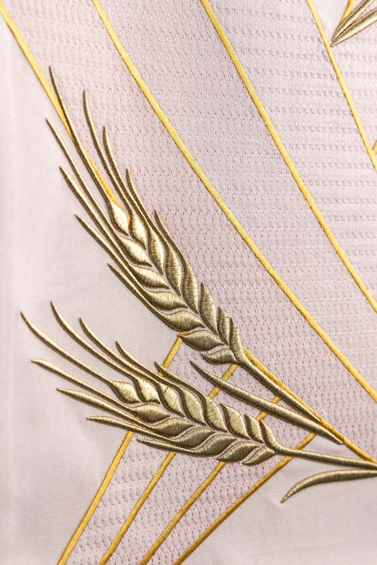 Church lectern cover detail showing the lower gold cross embroidery and wheat motif