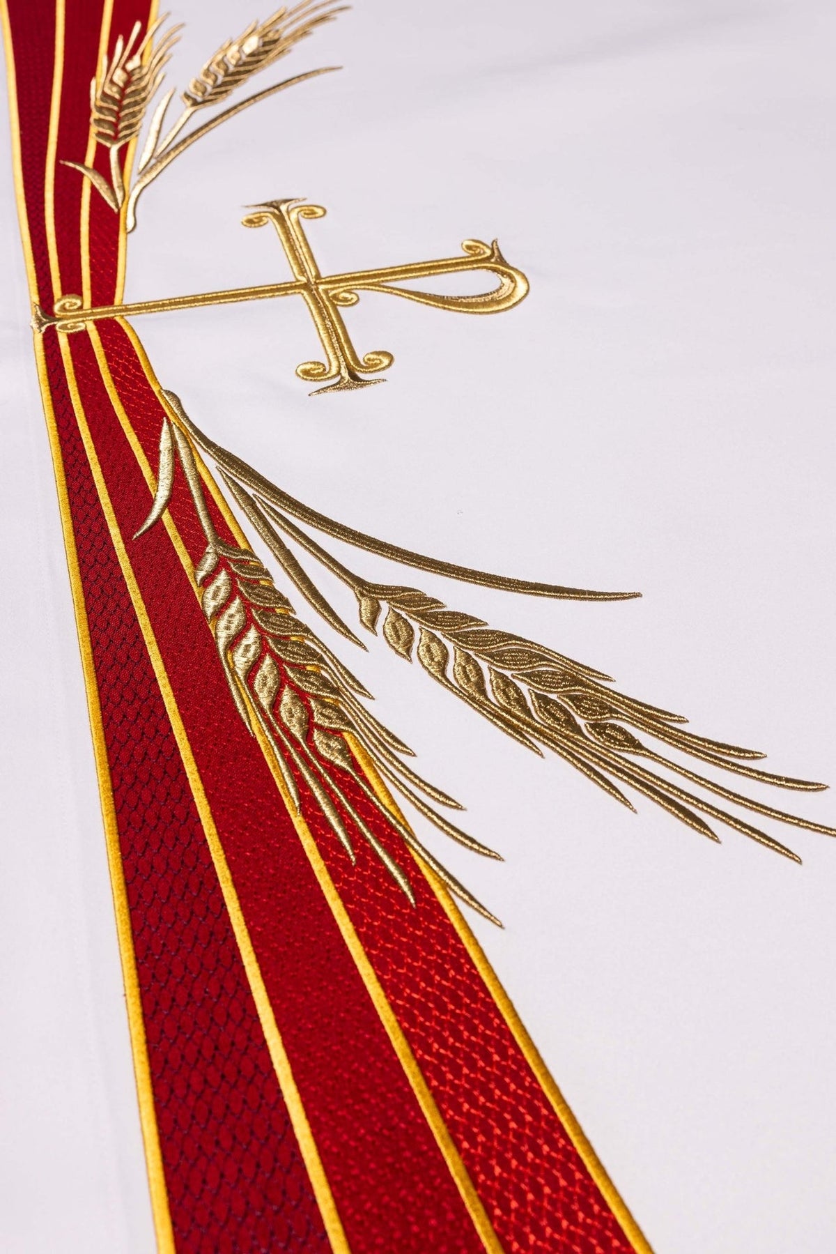 Altar cloth detail showing gold wheat embroidery beside red and gold bands