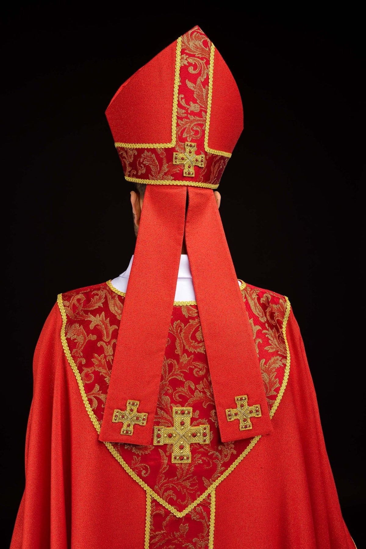 Red miter back view with gold cross, embroidered jacquard band and long red tails