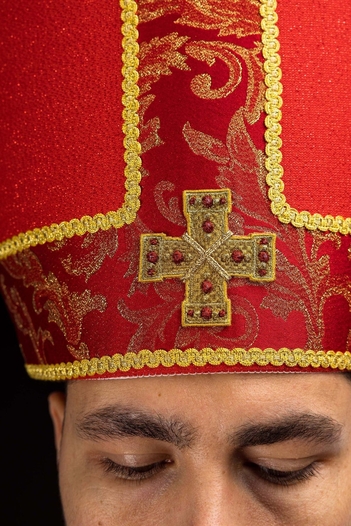 Red miter worn from the back with gold crosses, jacquard fabric and red tails