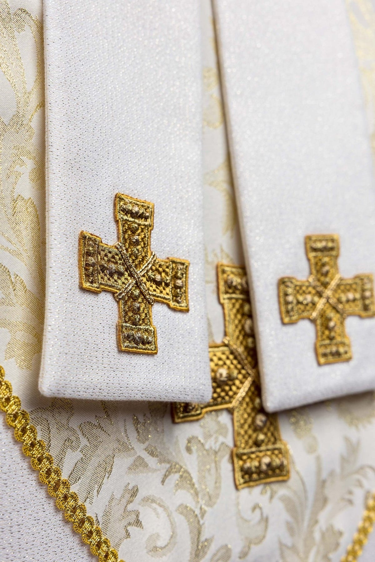 Ecru miter close-up with gold embroidered cross and trim